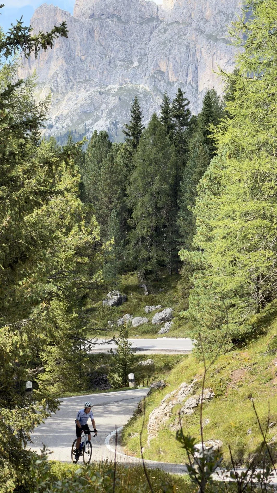 cyclist riding Passo Pordoi in the italian dolomites