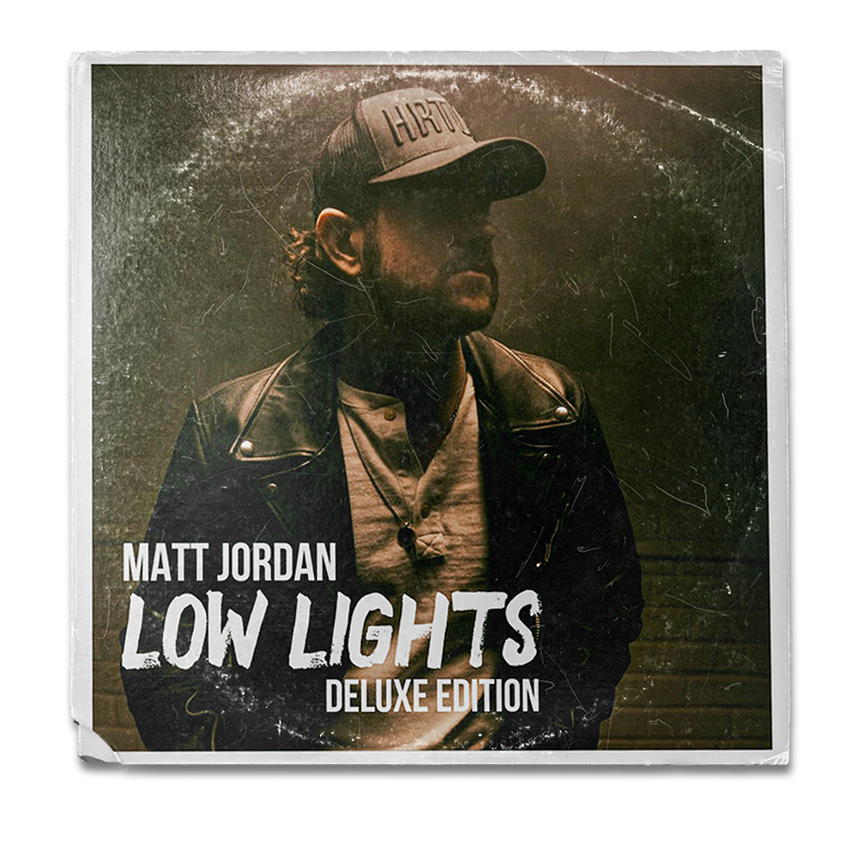 Album cover for Matt Jordan's "Low Lights Deluxe Edition" featuring a man in a leather jacket and baseball cap, with a dark background and a slightly distressed texture.
