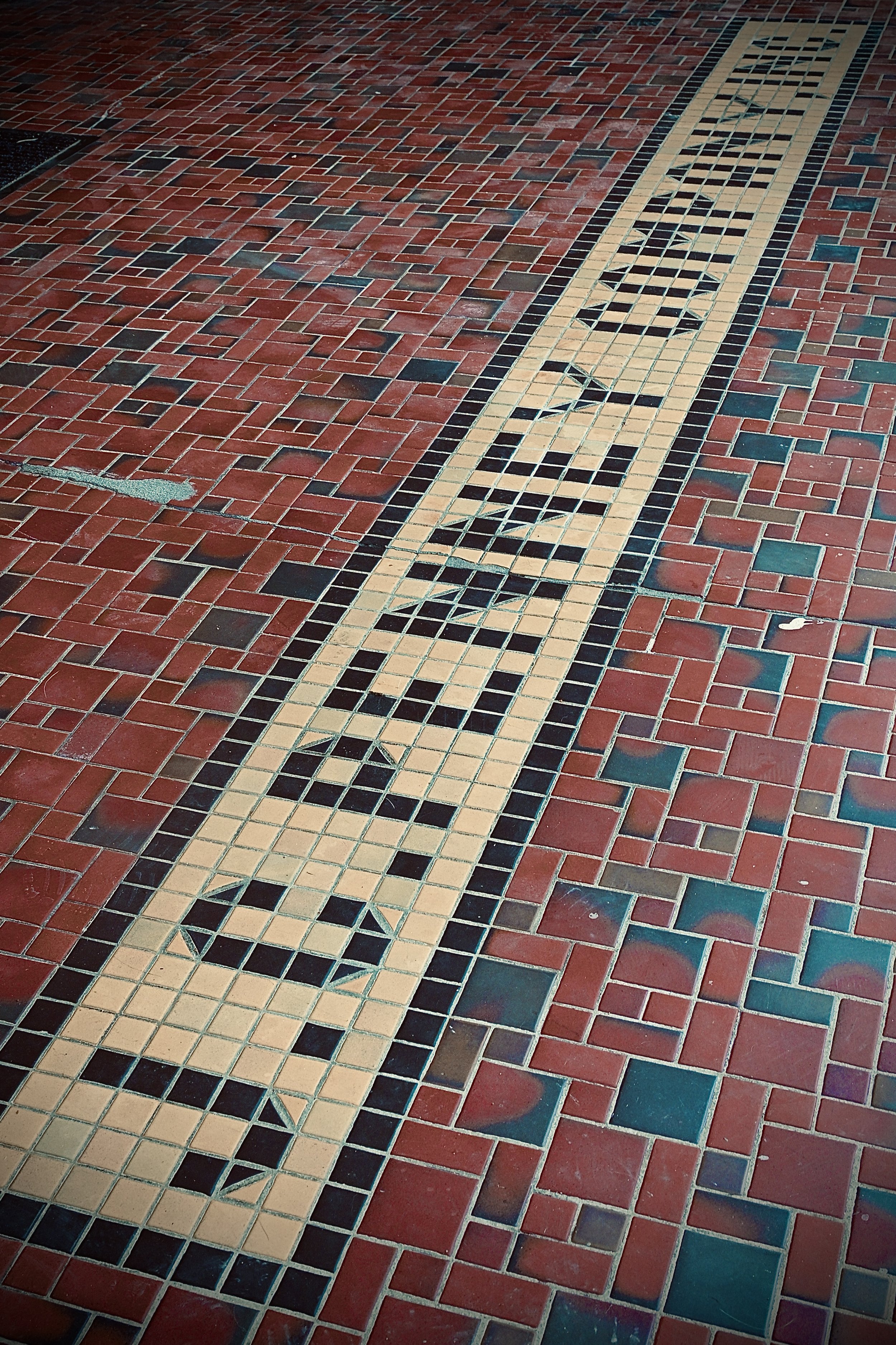 Close-up of a tiled "JC Penny Company" sidewalk in downtown Winchester KY