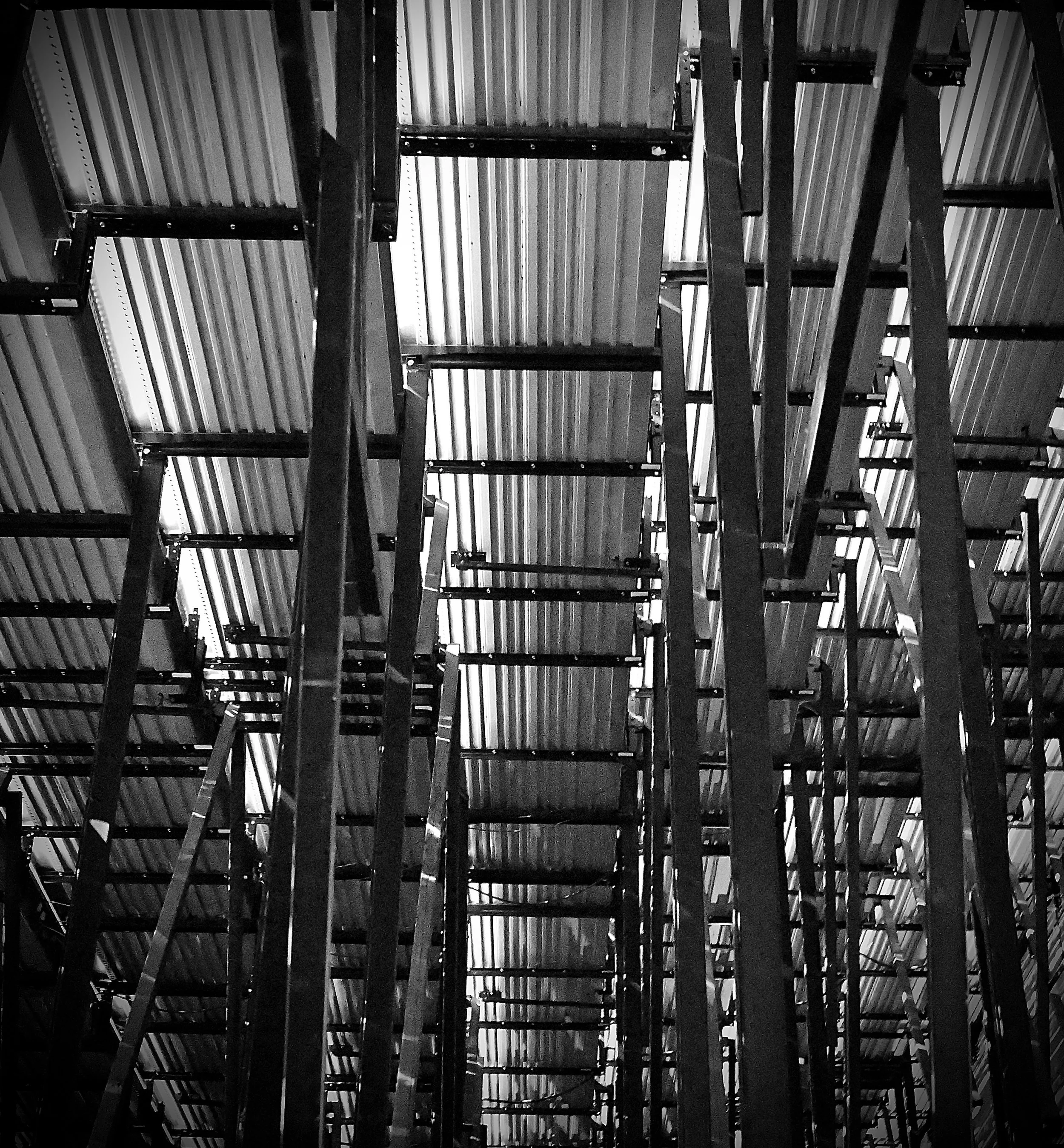Black and white photo taken fromn a vantage point under bleachers.