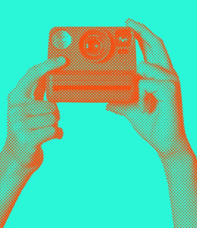 Polaroid camera held up by two hands in orange on a turquoise background