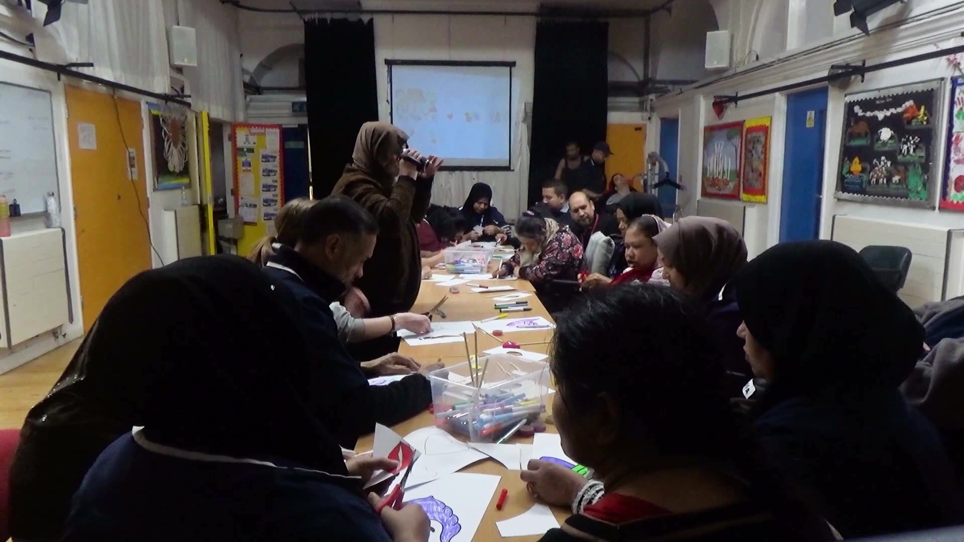 Bangladeshi Parents and Carers Association drawing at a long table