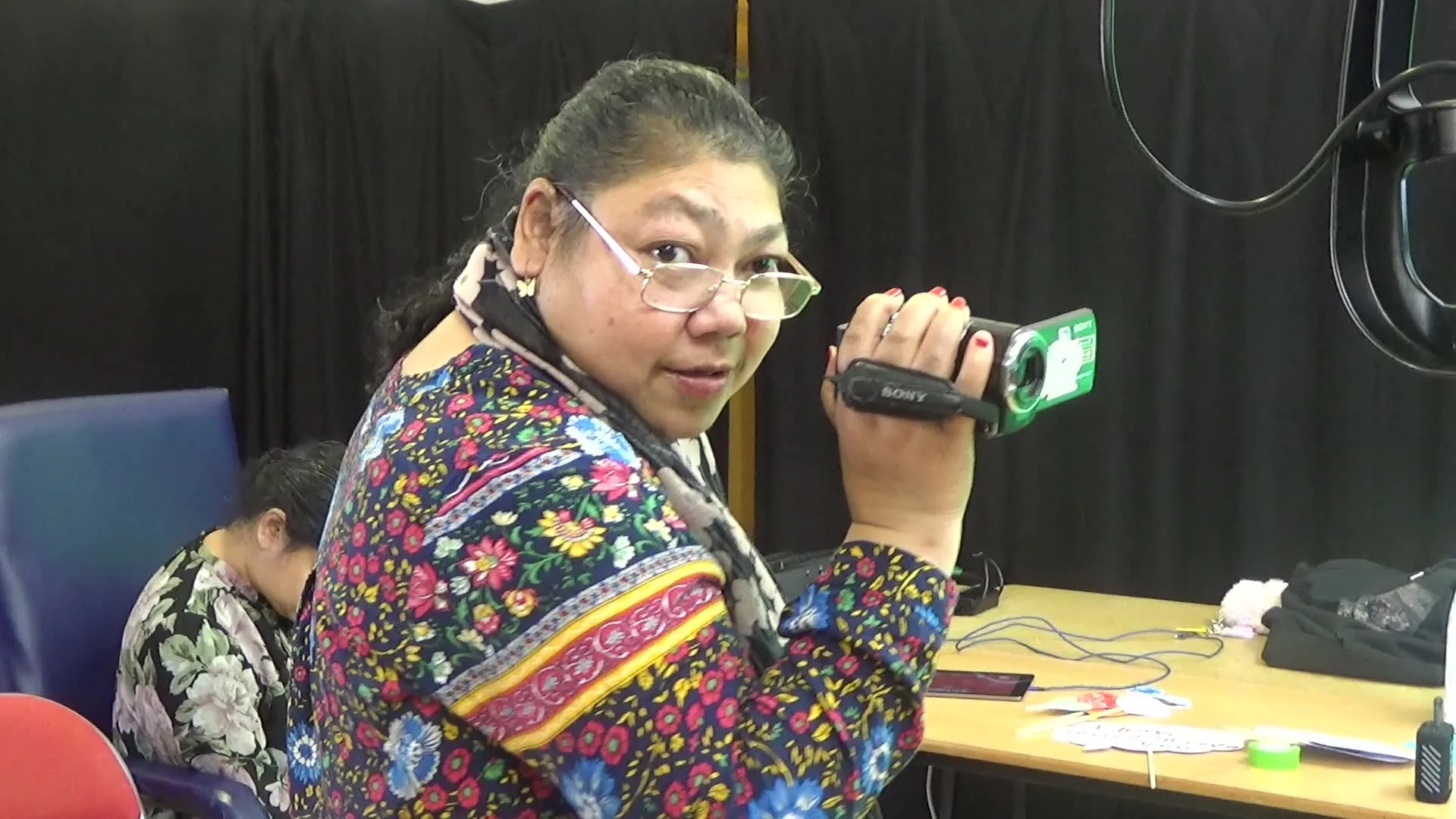 Woman filming using a camcorder