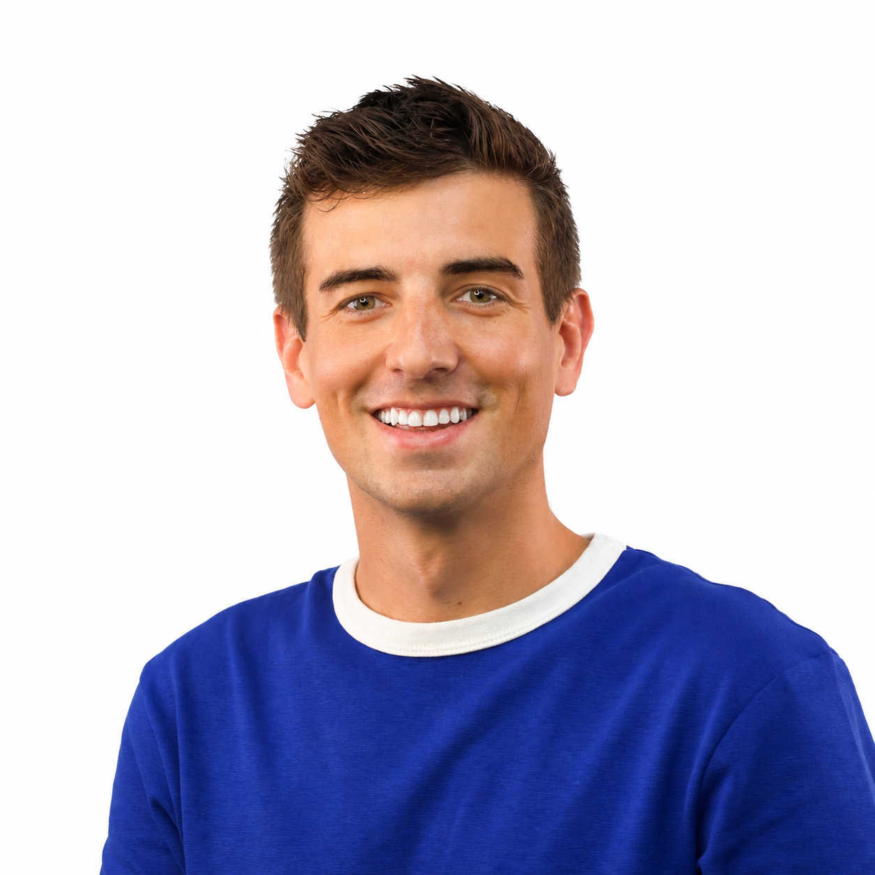 A young man with brown hair wearing a blue t-shirt with a white collar, smiling against a plain white background.