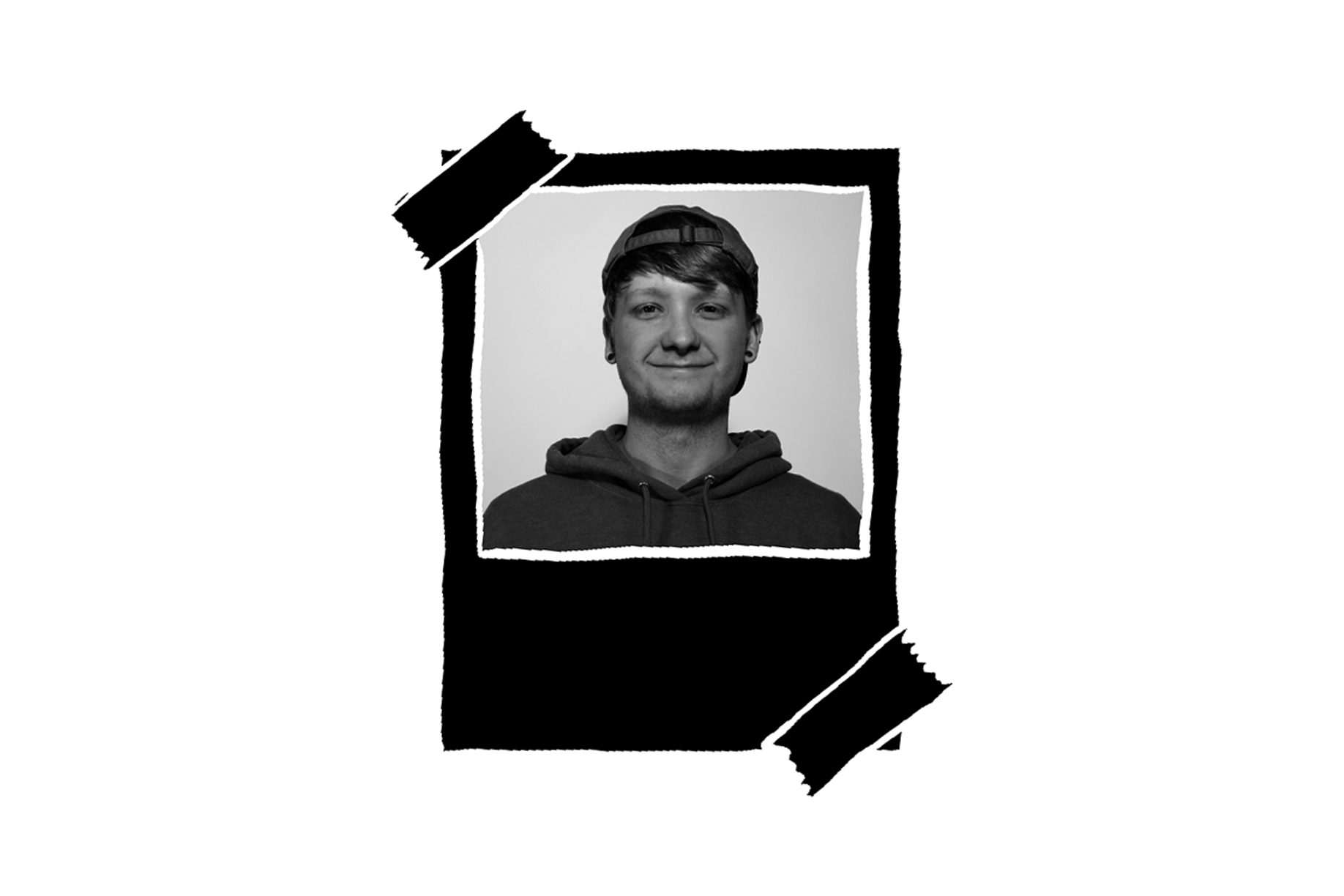 Black and white portrait of a young man with short hair, a backwards cap, and earrings, wearing a hoodie, smiling slightly.