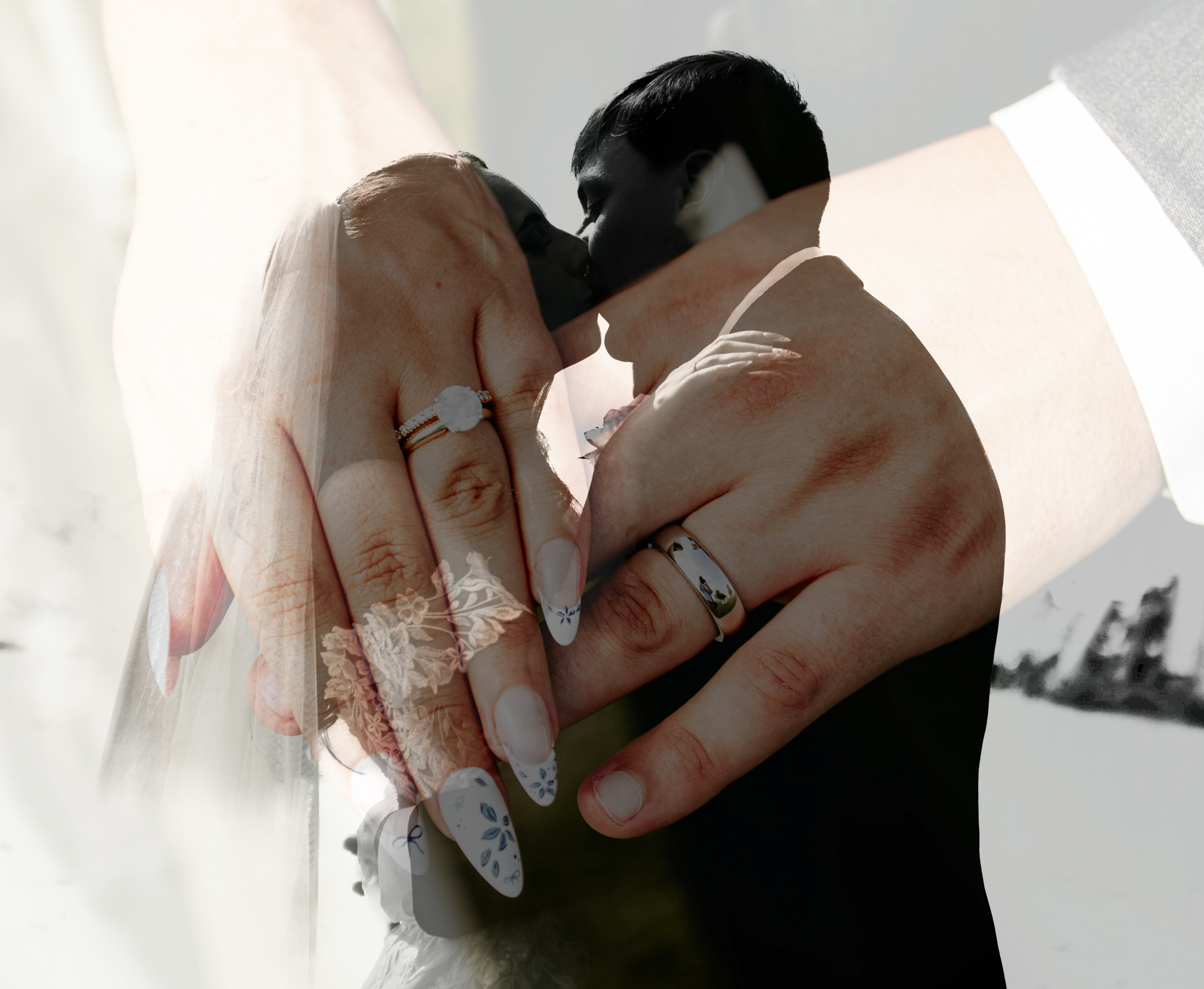 Close-up of a couple holding hands during their wedding, with the bride wearing a wedding dress and the groom in a suit, against a bright, slightly blurred outdoor background.
