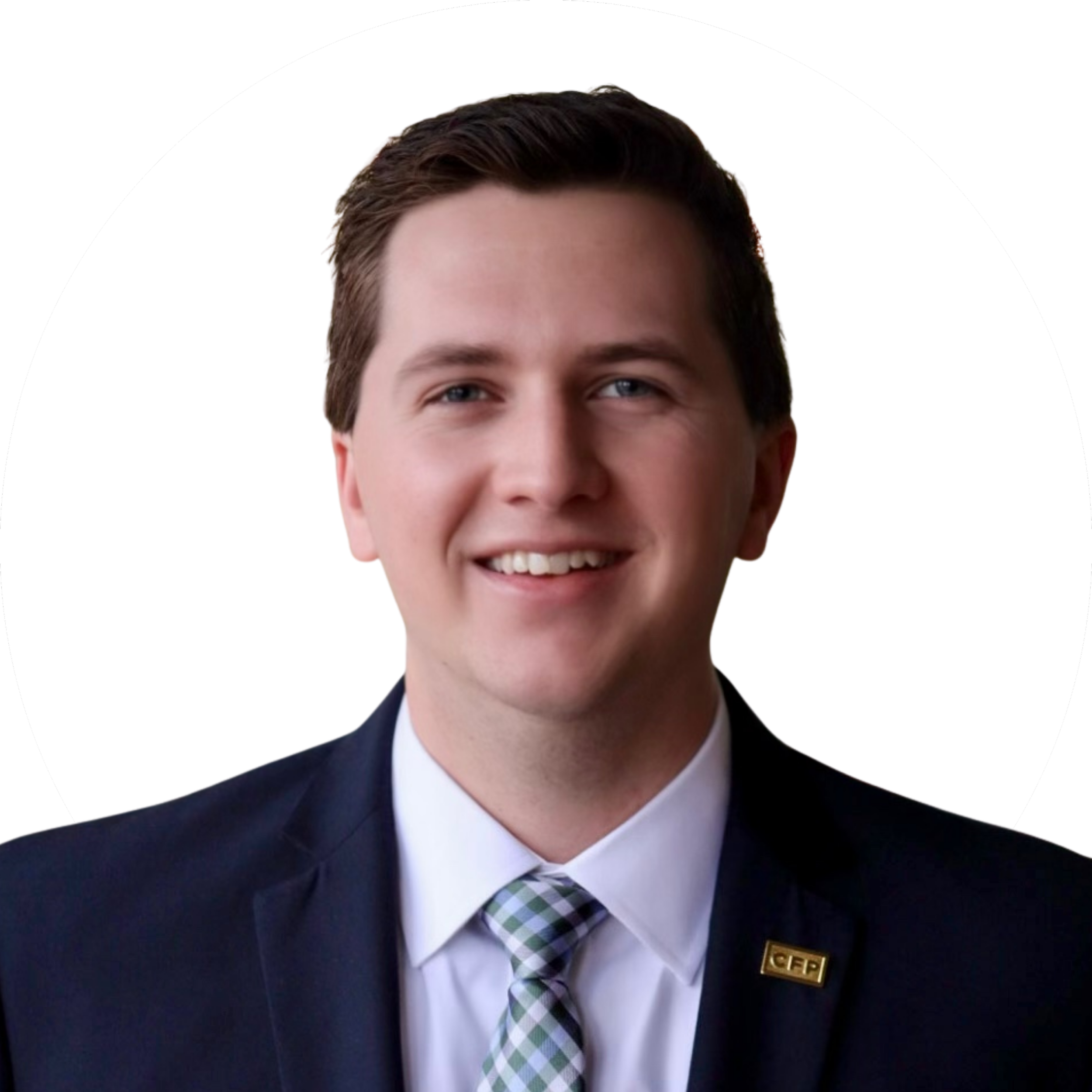 Professional headshot of a young man with short brown hair, blue eyes, wearing a dark suit, light-colored dress shirt, and a checkered tie, smiling, against a plain white background.