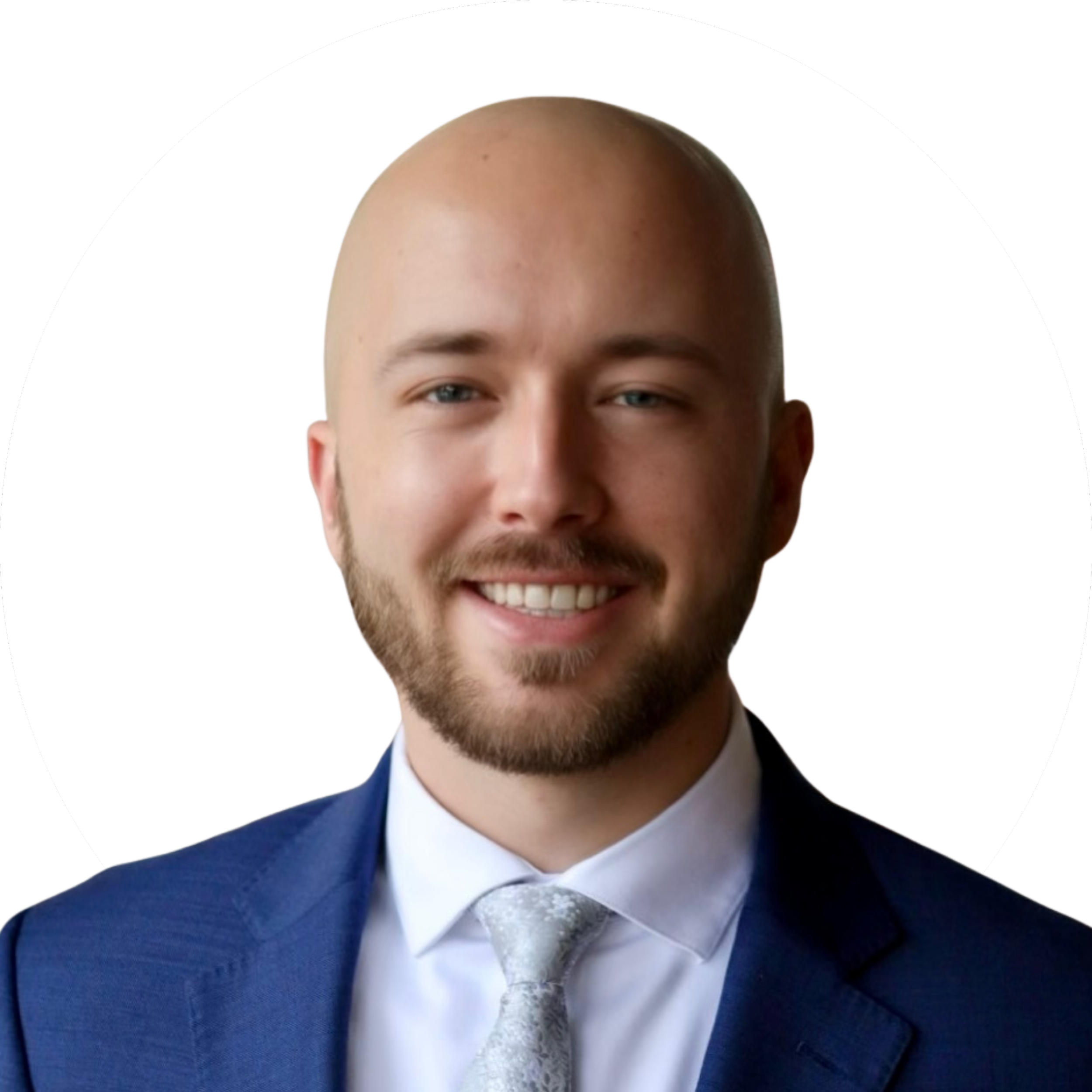 Headshot of a smiling man with a beard, wearing a blue suit, white shirt, and light gray tie, against a white circular background.