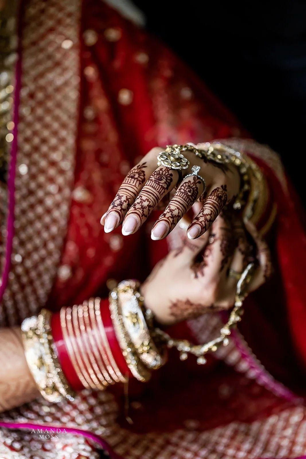 close up of indian bride's hands with henna detail and jewelry