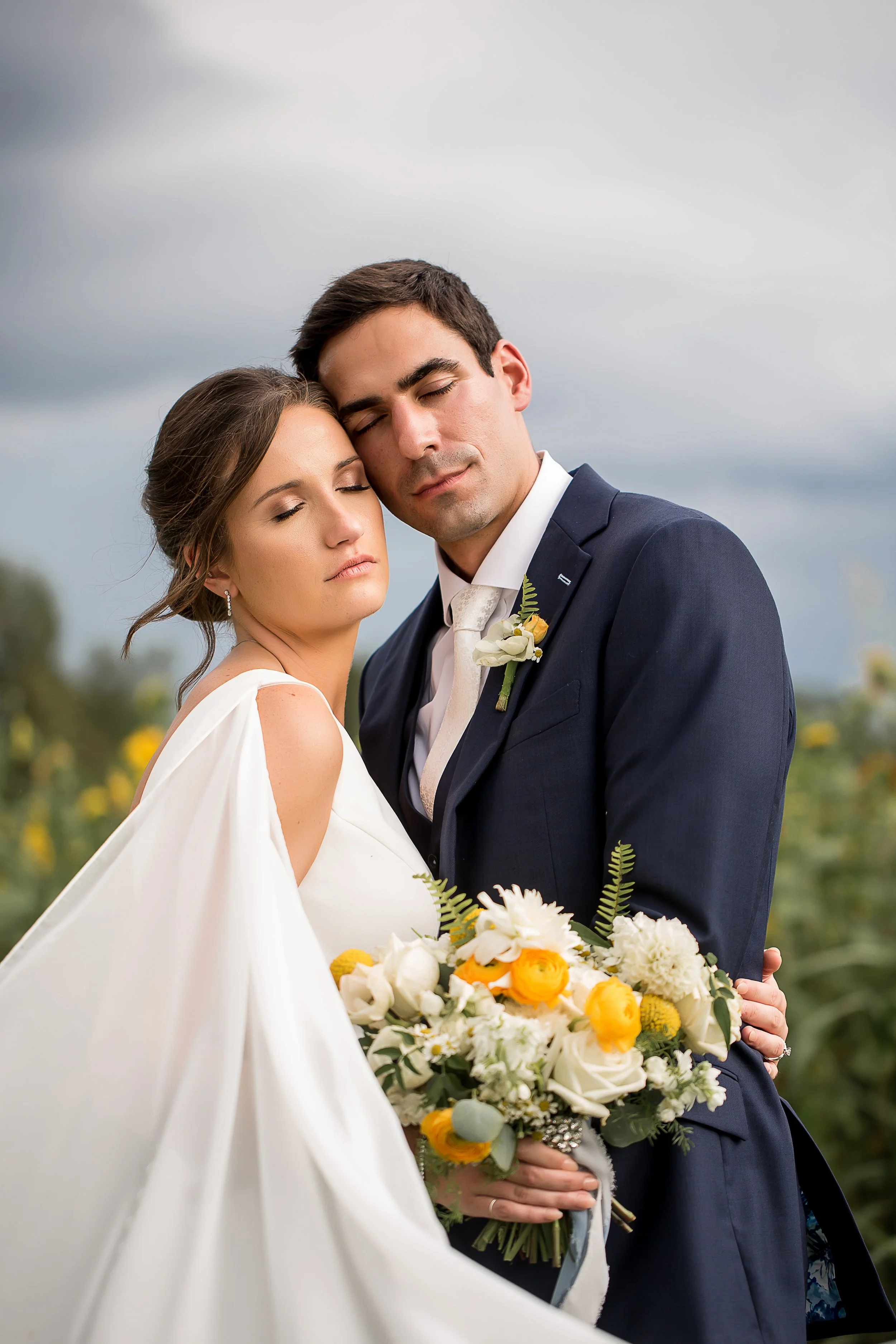 calm relaxed beautiful portrait of bride and groom with their eyes closed and faces touching