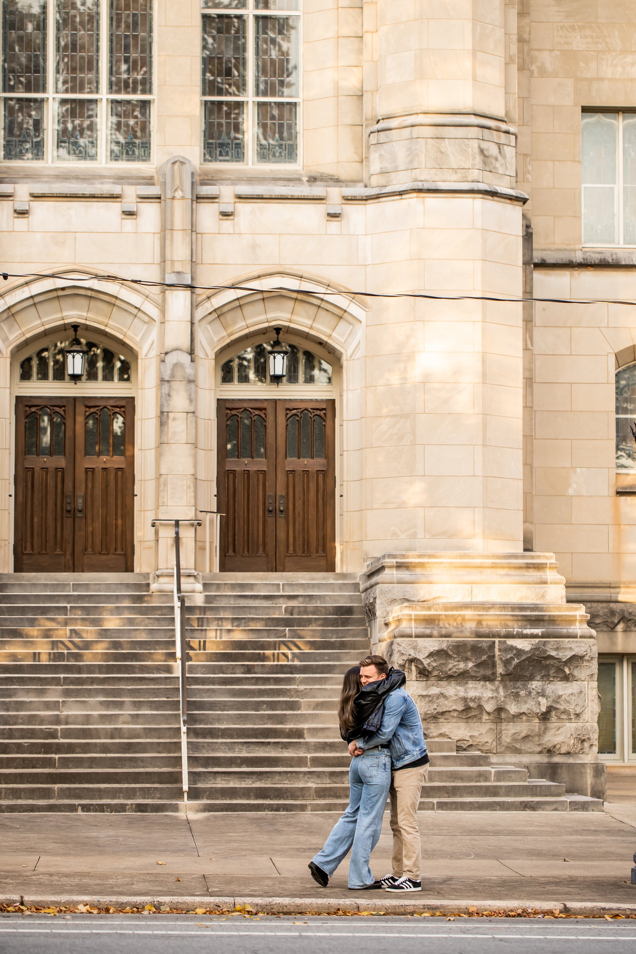 couple embraces after surprise proposal in charlotte nc in front of old church steps