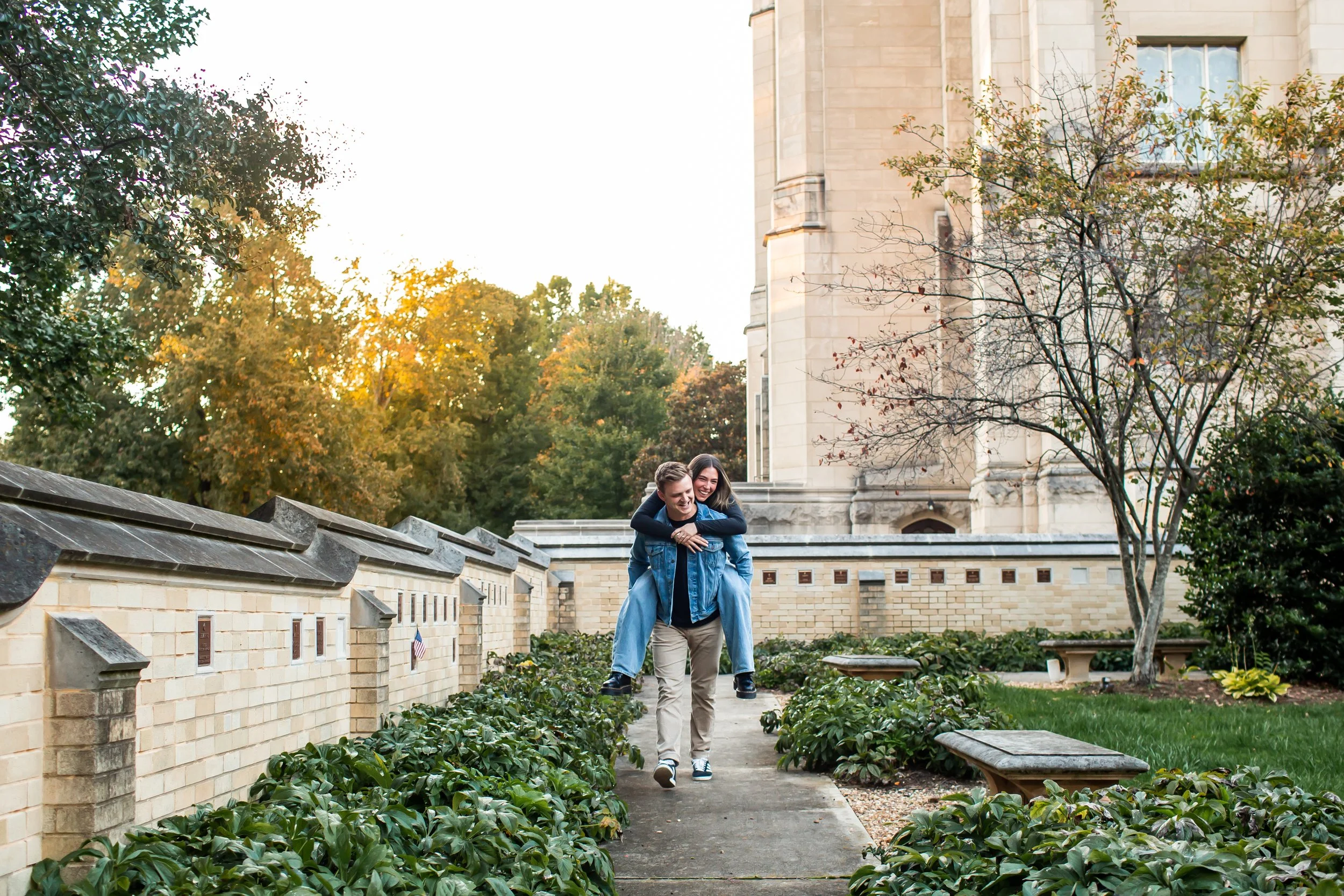 couple rides piggyback during evening walk after surprise proposal in charlotte nc