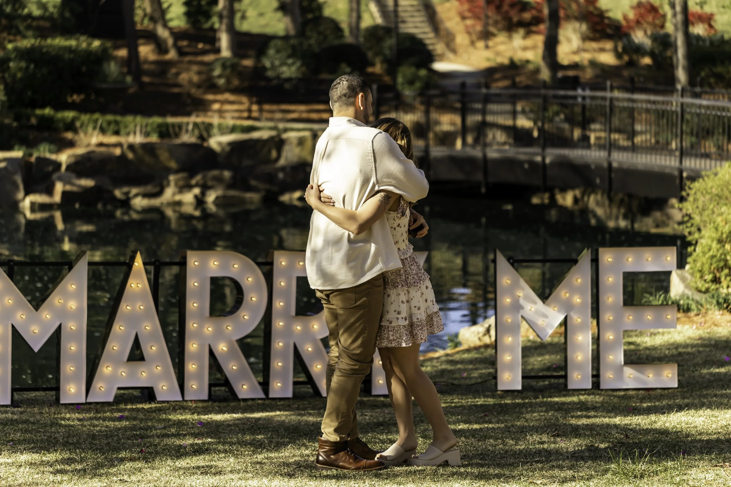 Bride-to-be reacting with joy and surprise during proposal at Cullman Park