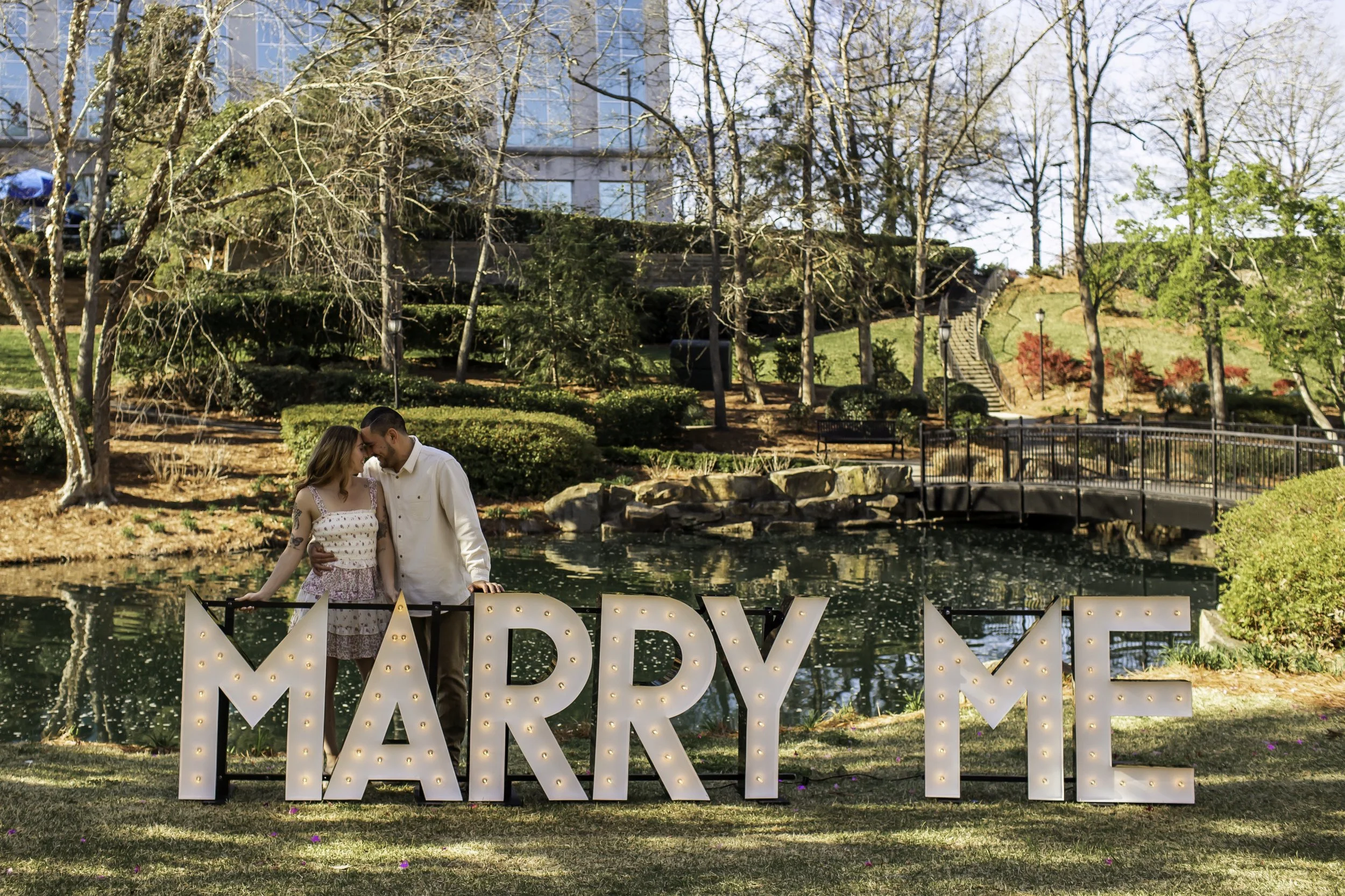 Emotional moment between newly engaged couple at Cullman Park, captured after surprise proposal