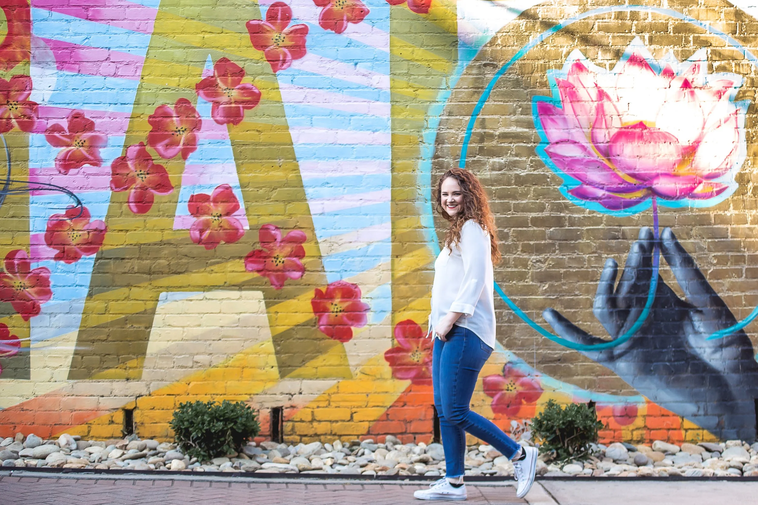 woman walking in front of mural noda neighborhood charlotte nc portrait photographer
