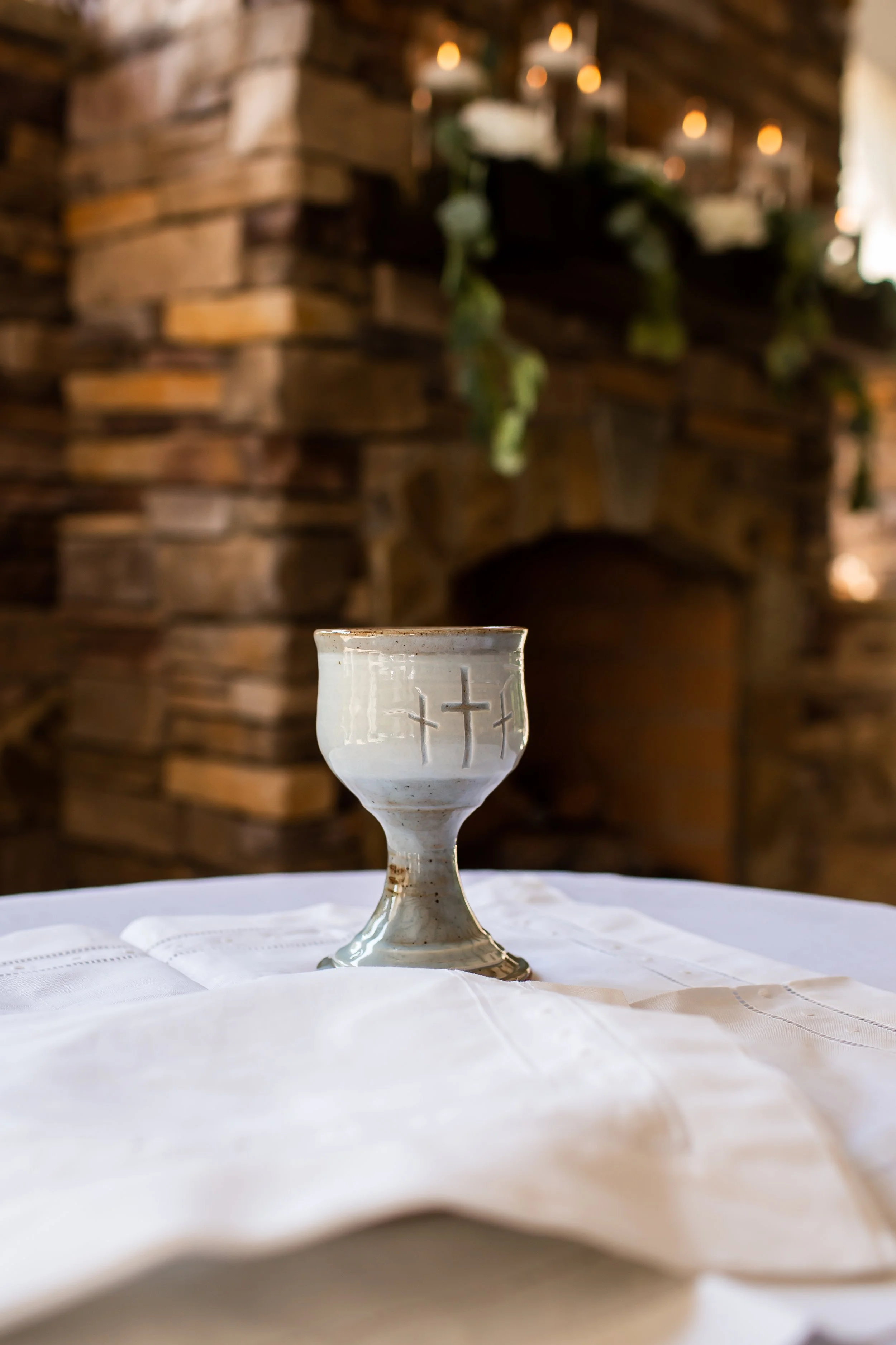 detail photo of wine chalice and breaking of bread wedding ceremony