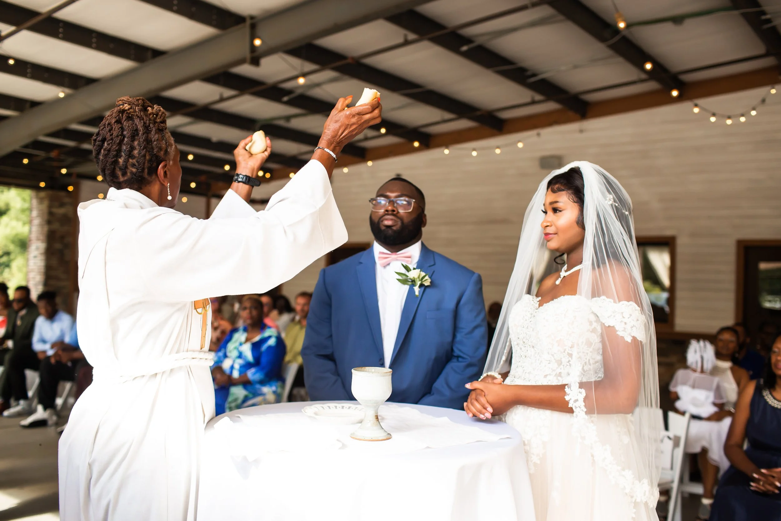 african american wedding couple breaking bread during ceremony huntersville nc magnolia woods