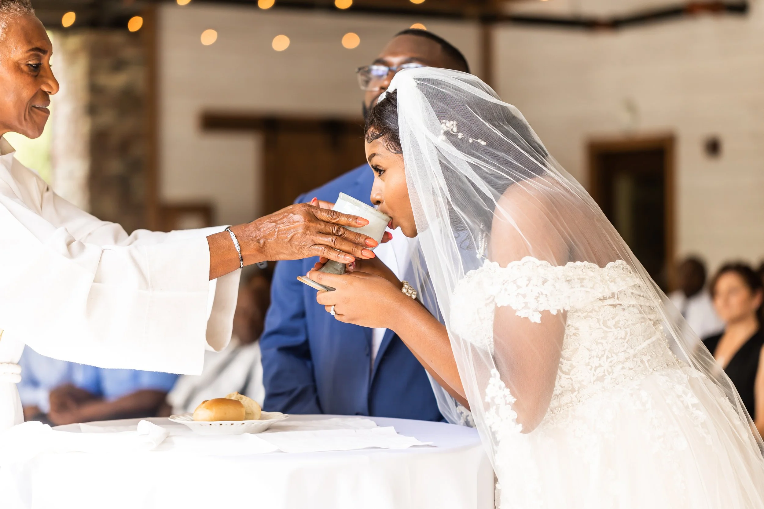 african american couple drinks wine during bread breaking wedding ceremony charlotte north carolina