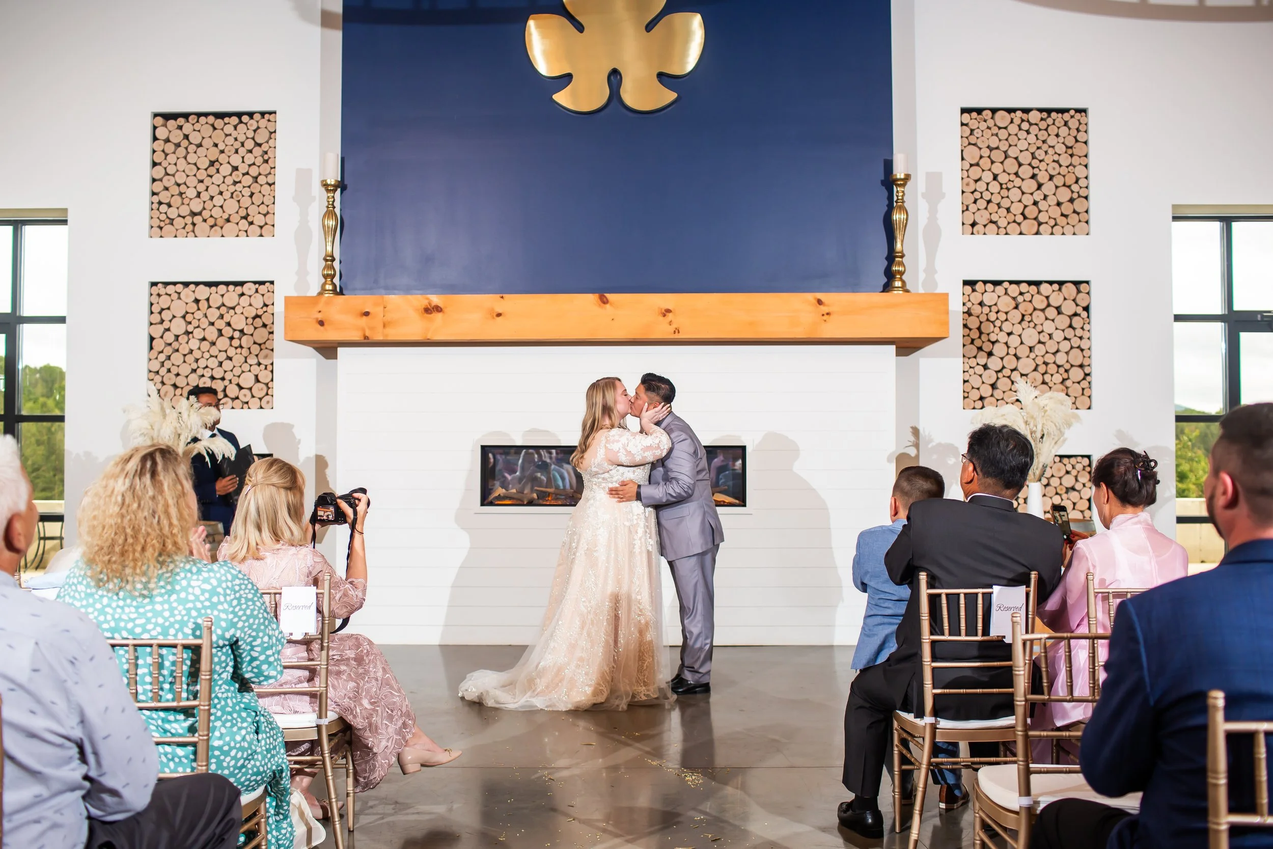 indoor ceremony at veronet vineyards bride and groom first kiss
