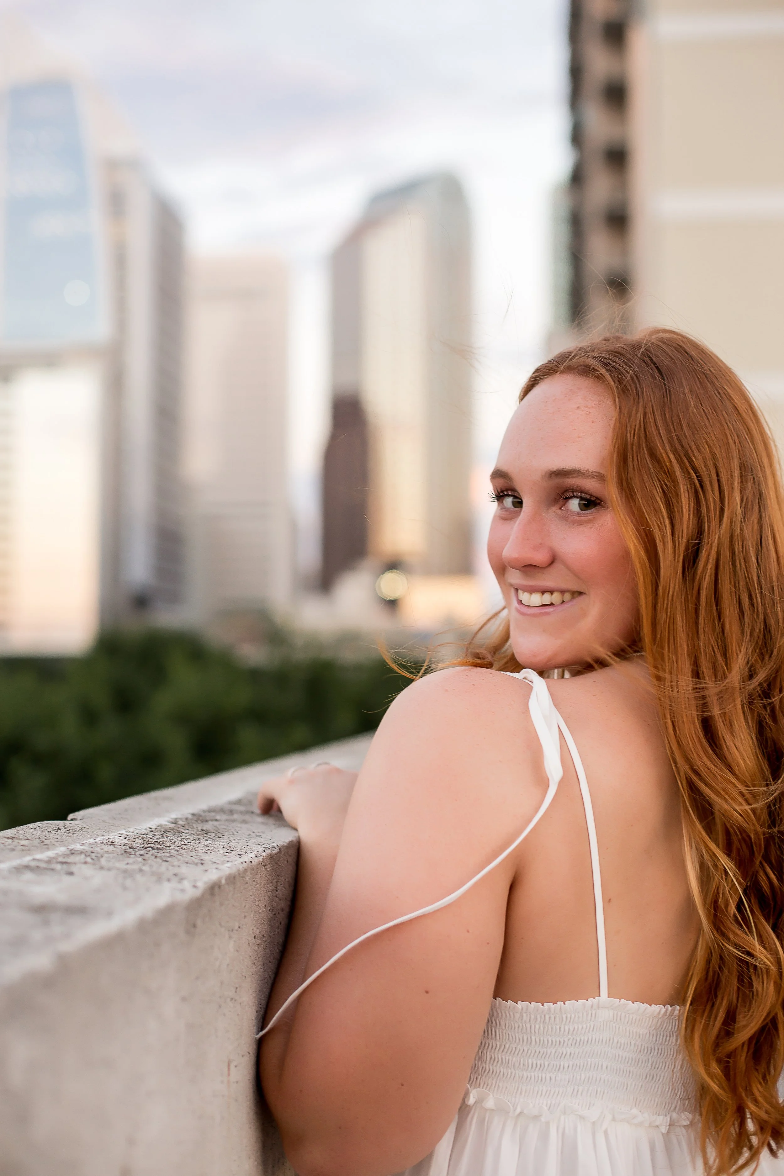 close up portrait of redhead high school senior in white dress