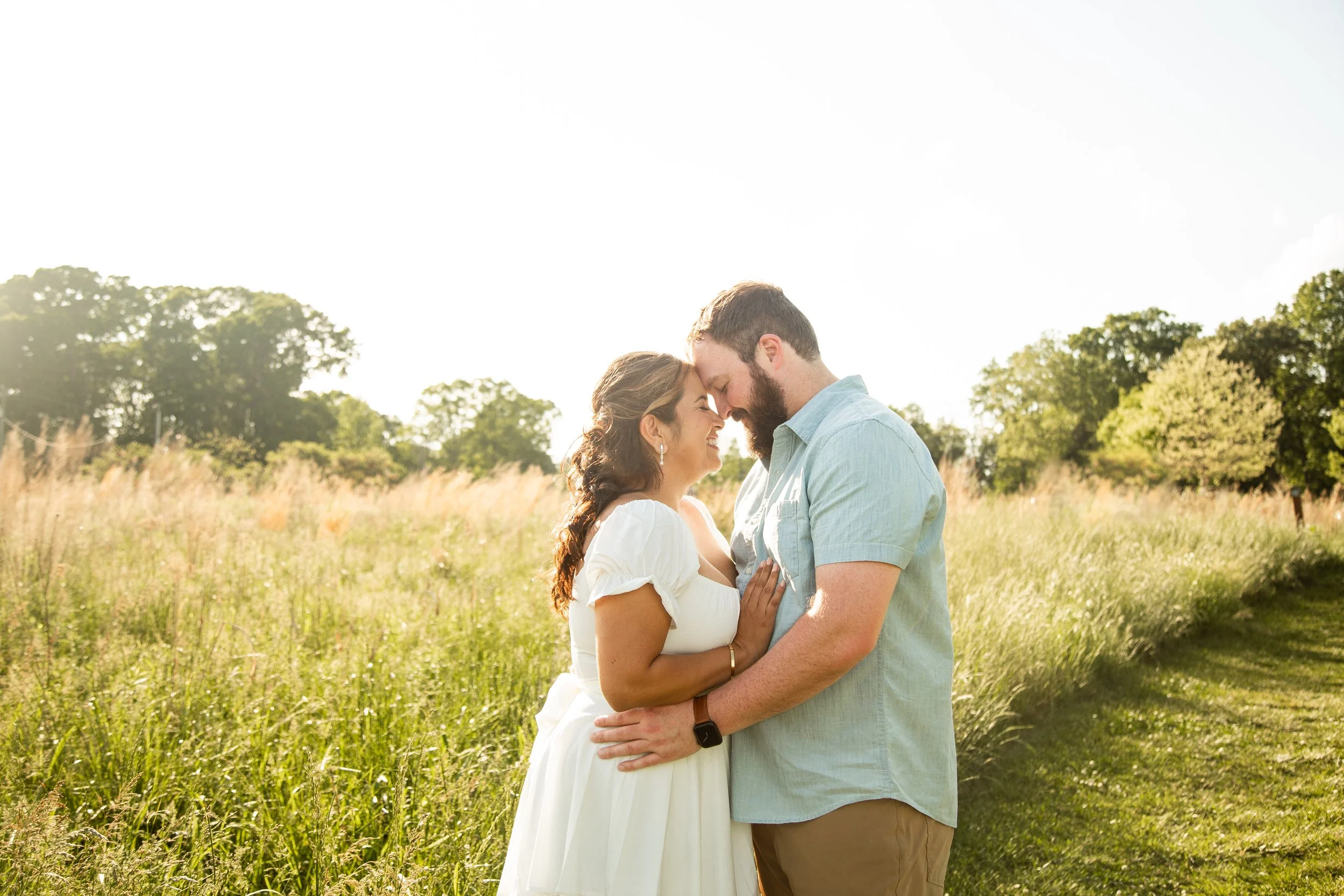 Romantic close-up portrait of Vanessa and Alex surrounded by greenery and wildflowers at Clark's Creek Nature Preserve