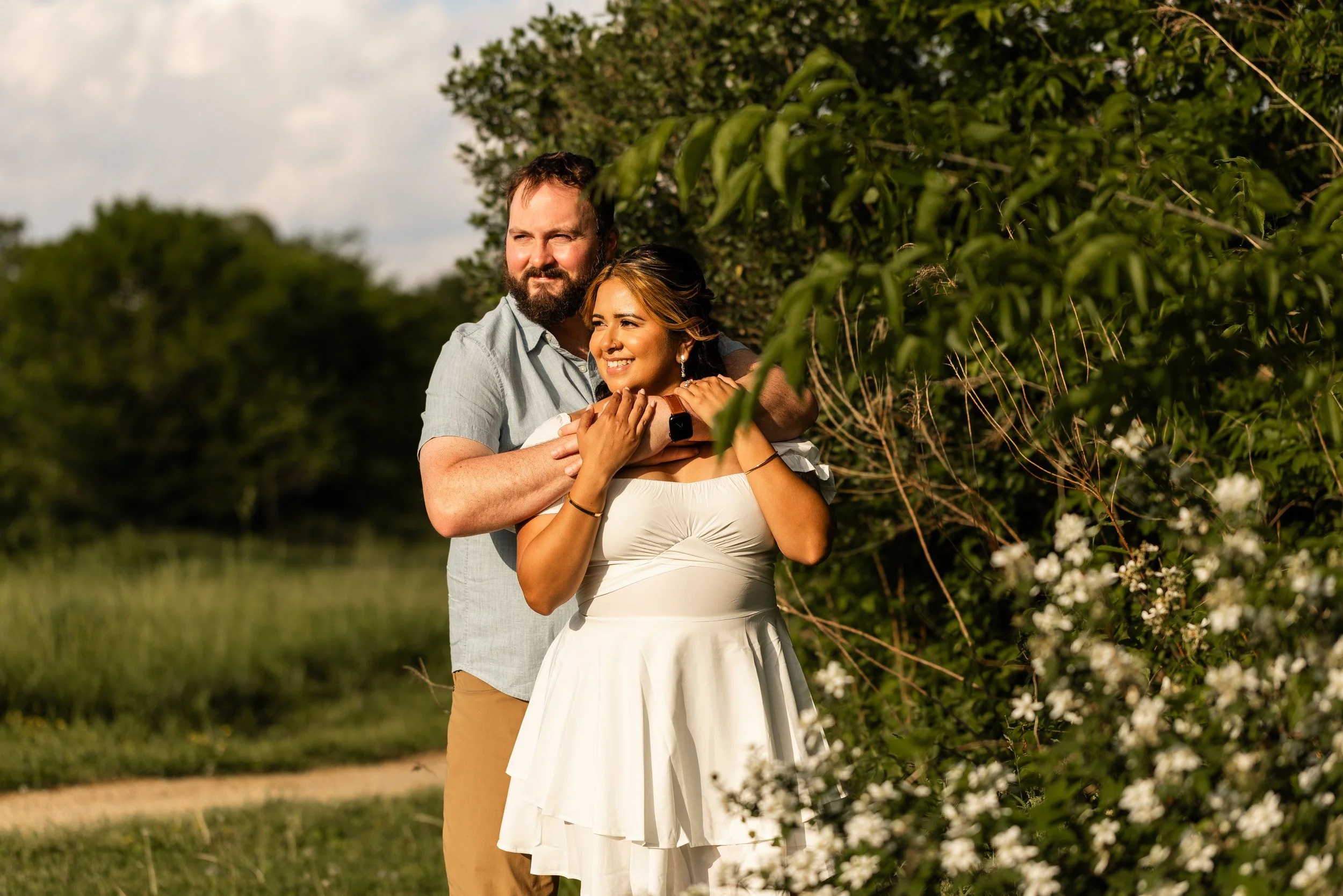Golden hour engagement photo at Clark's Creek Nature Preserve with soft sunlight highlighting the couple's natural chemistry