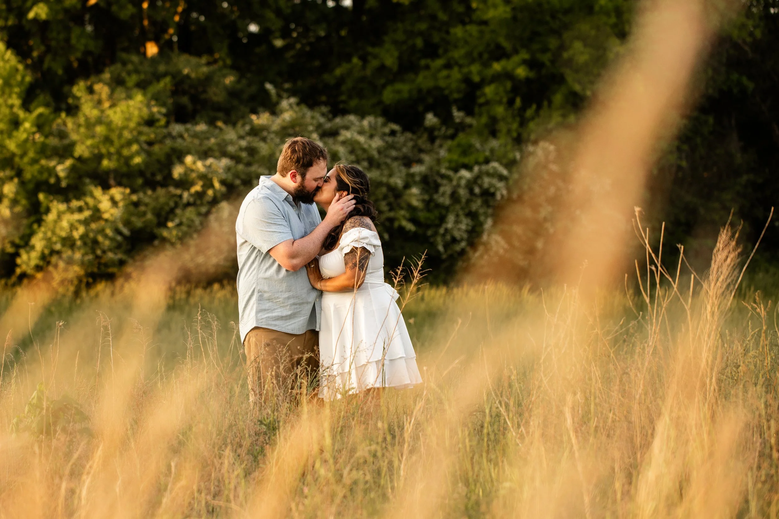 Golden hour engagement photo at Clark's Creek Nature Preserve with soft sunlight highlighting the couple's natural chemistry
