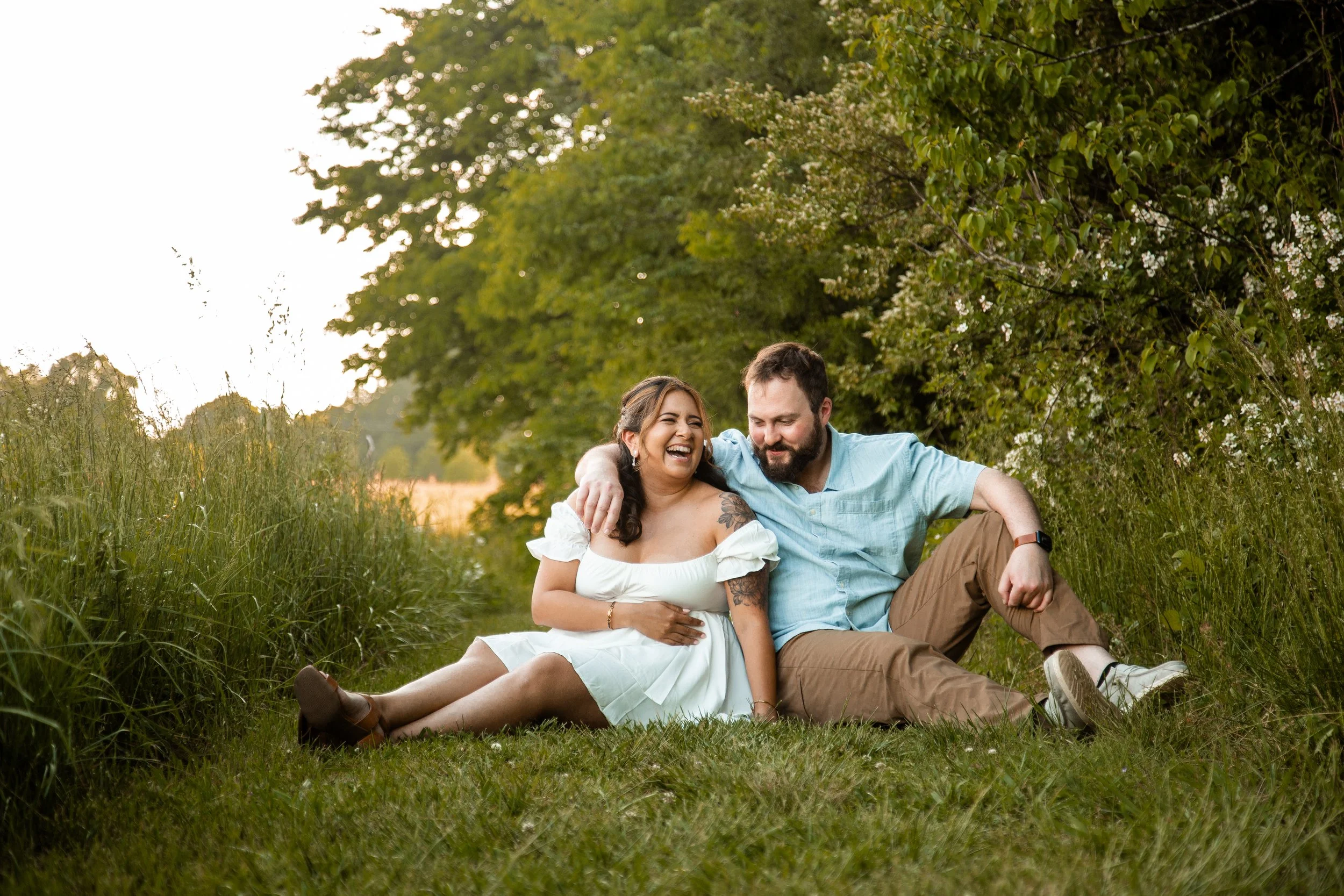 Vanessa and Alex sharing a quiet moment among white wildflowers at Clark's Creek Nature Preserve during their engagement session