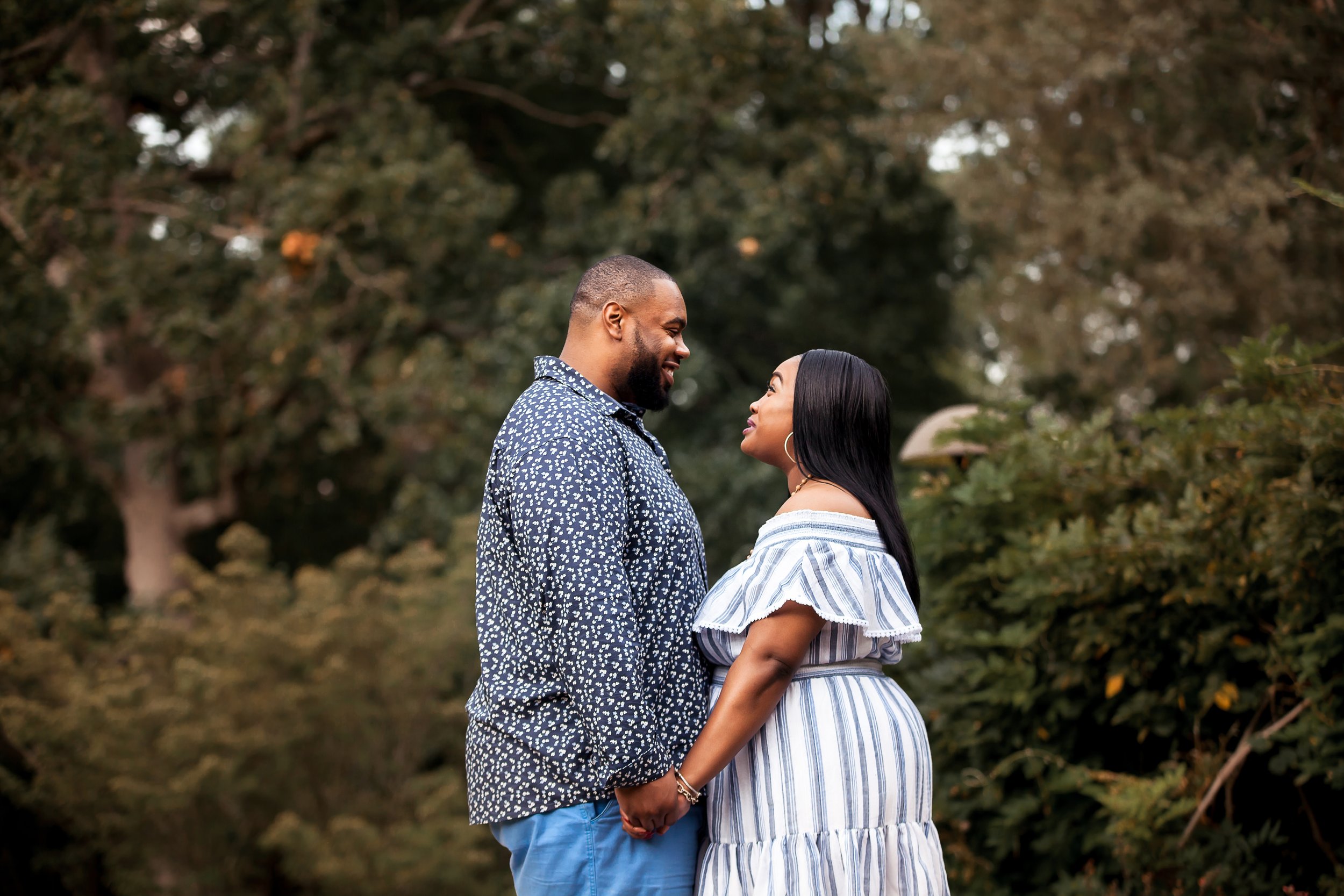 engaged african american couple gazes into each others eyes spring engagement