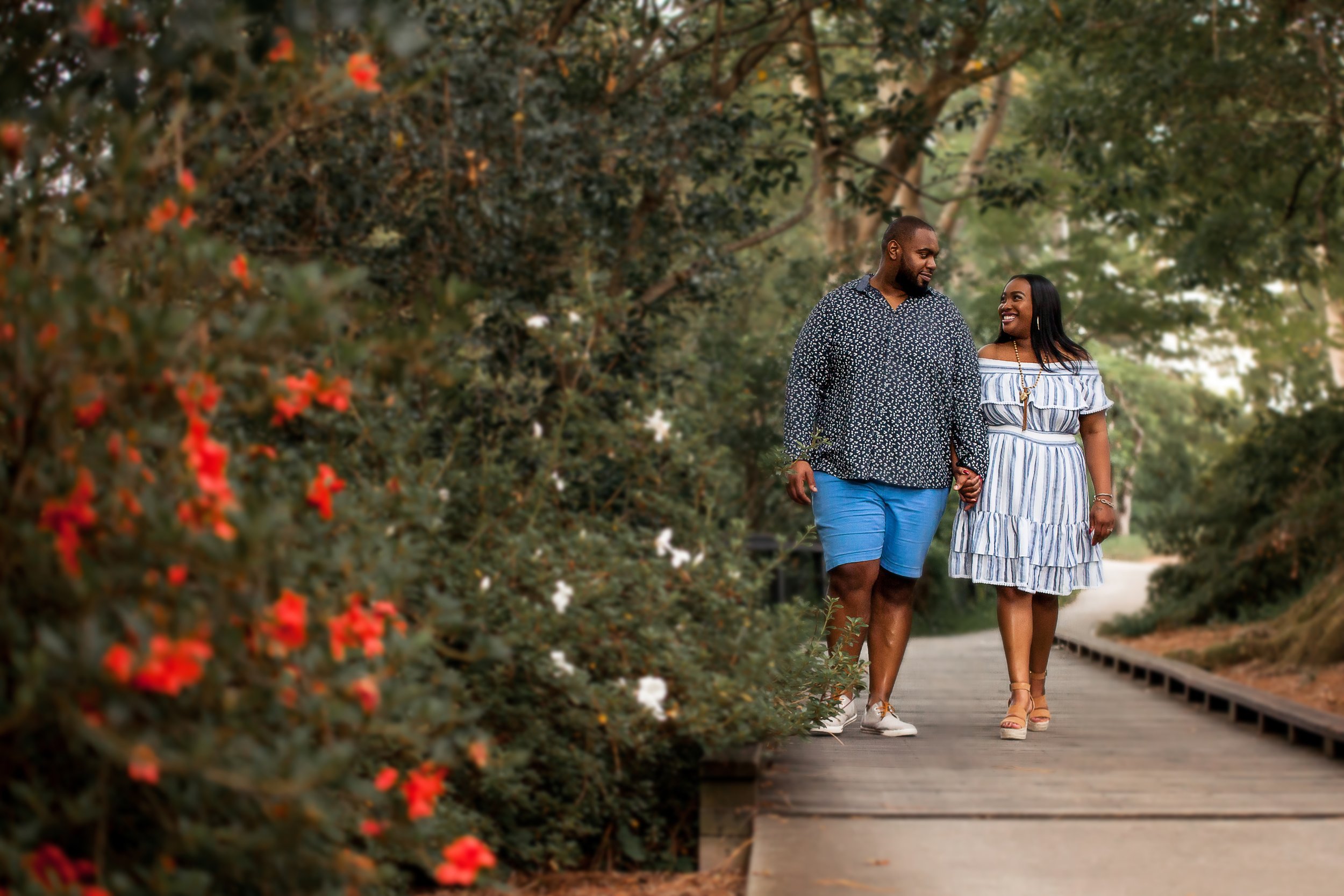 black couple walks through park engagement photos north carolina SC glencairn gardens