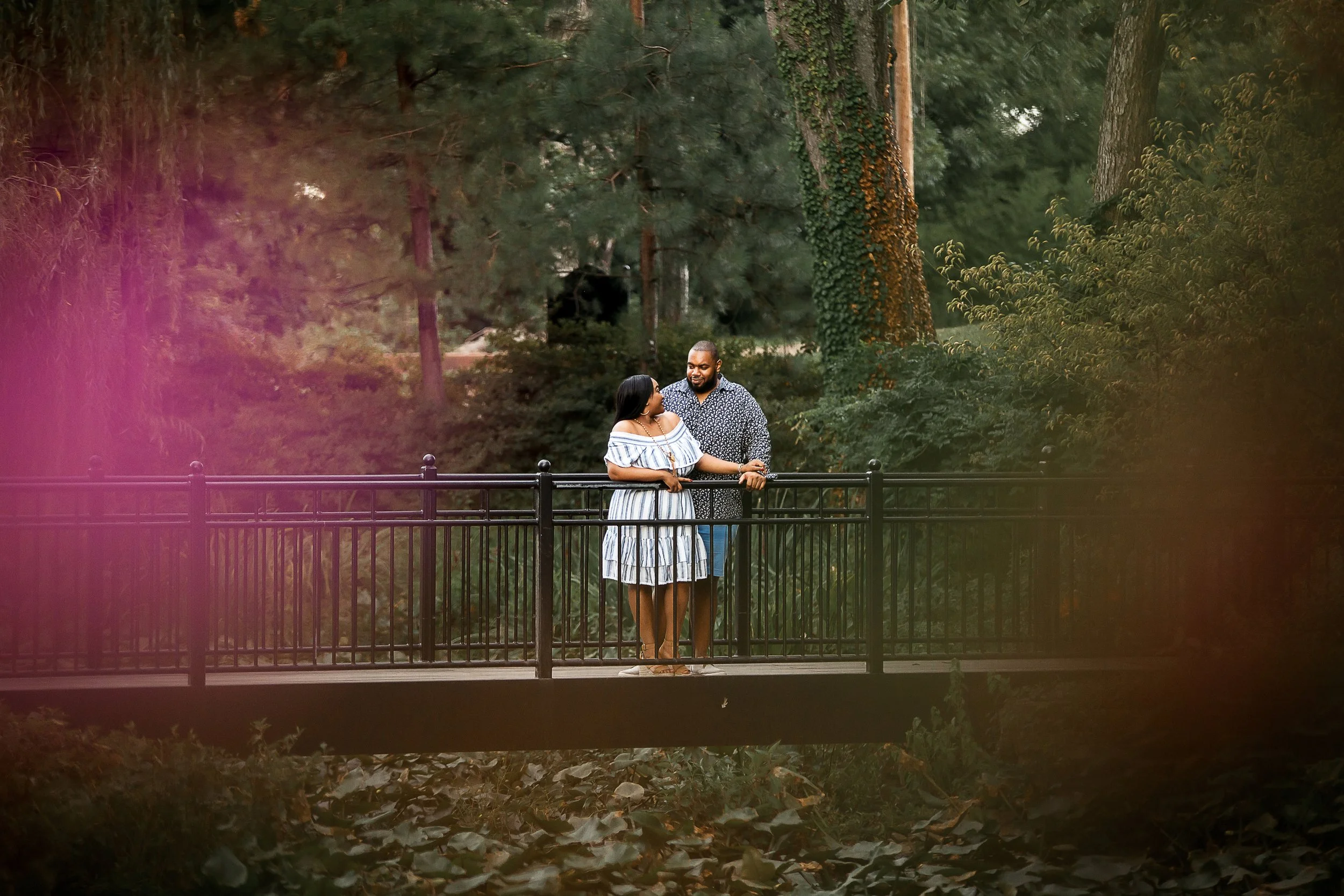 couple over bridge engagement session