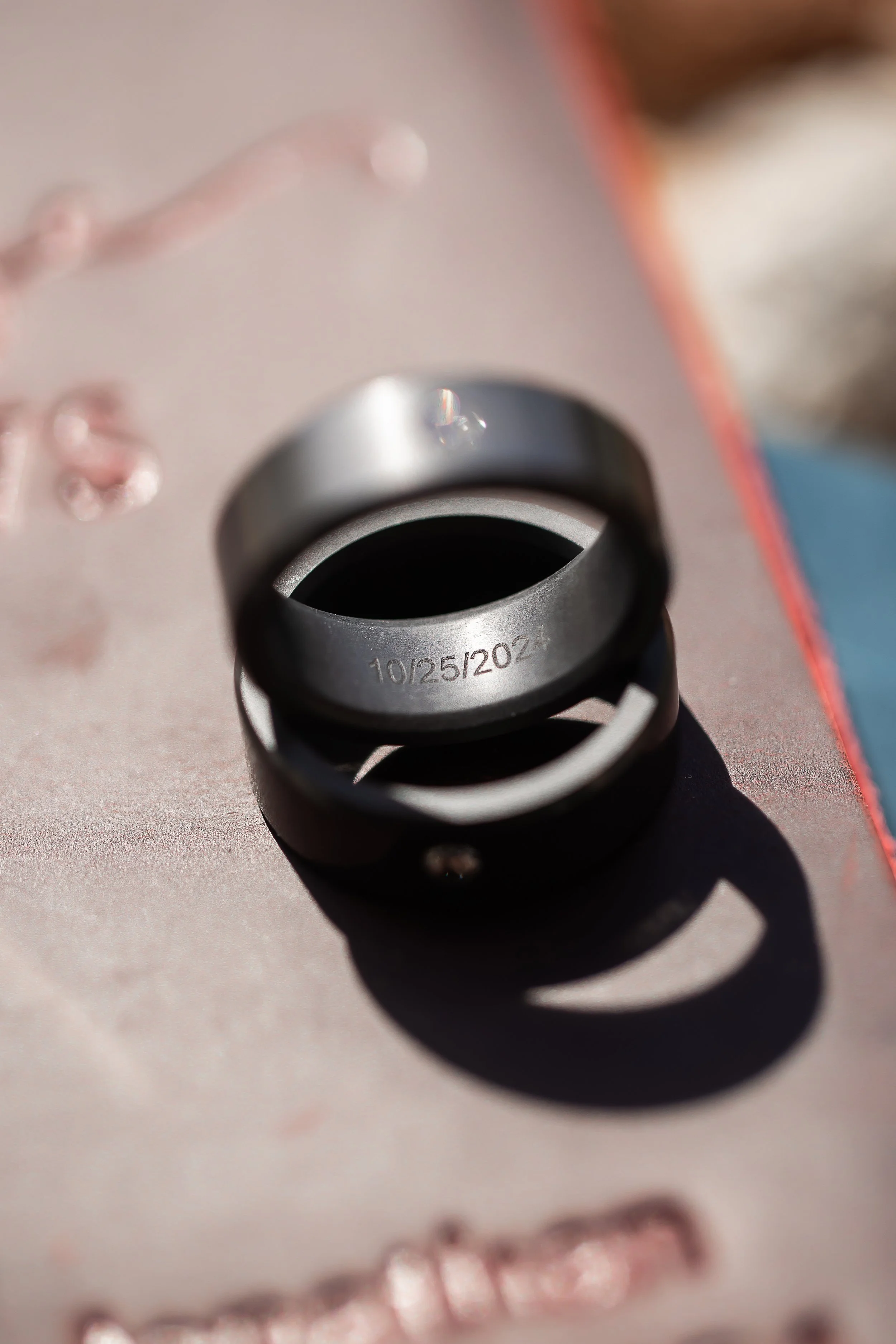 Dramatic ring shot with strong shadows highlighting the ring engraving.