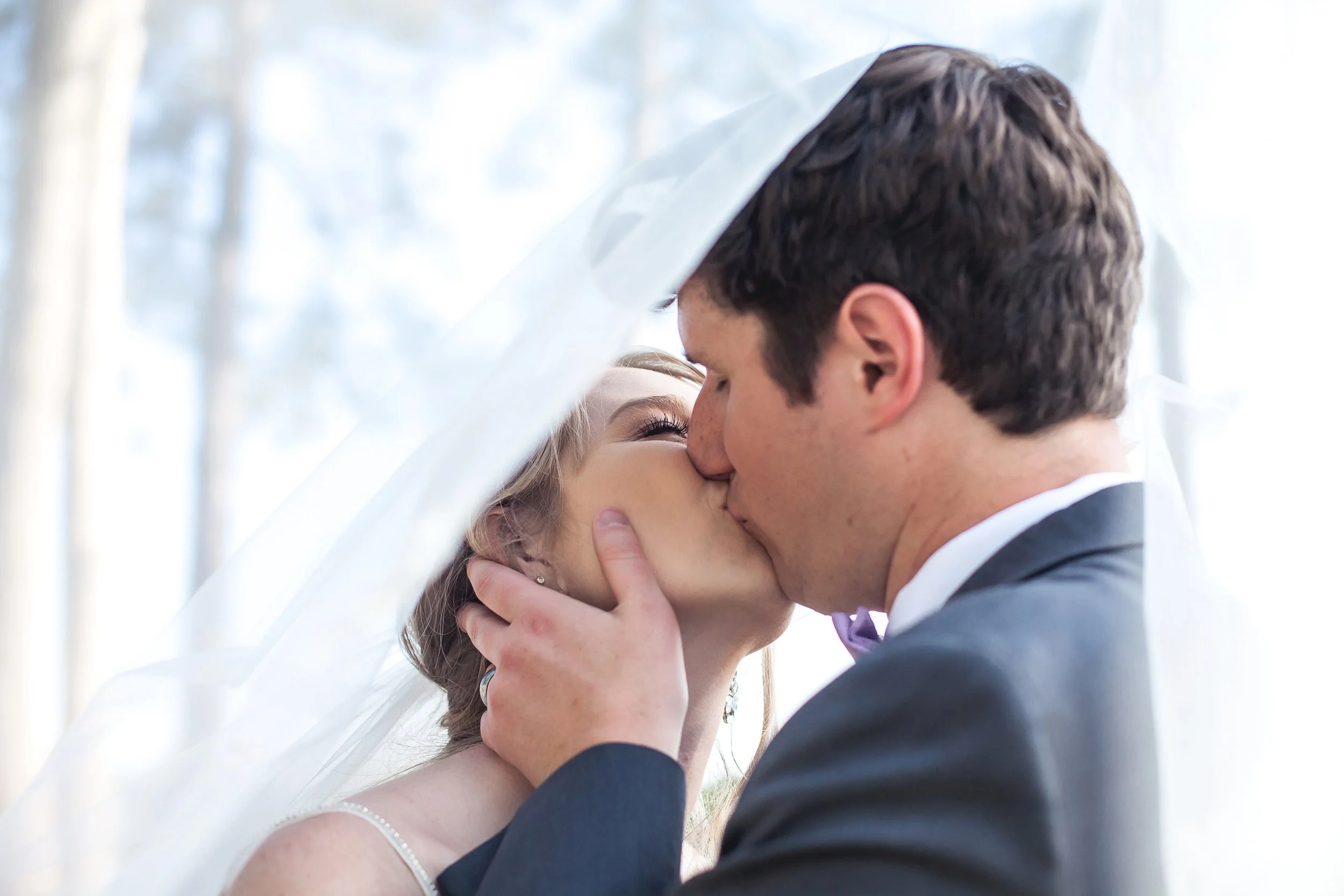 bride and groom kiss under veil charlotte nc micro wedding lake norman