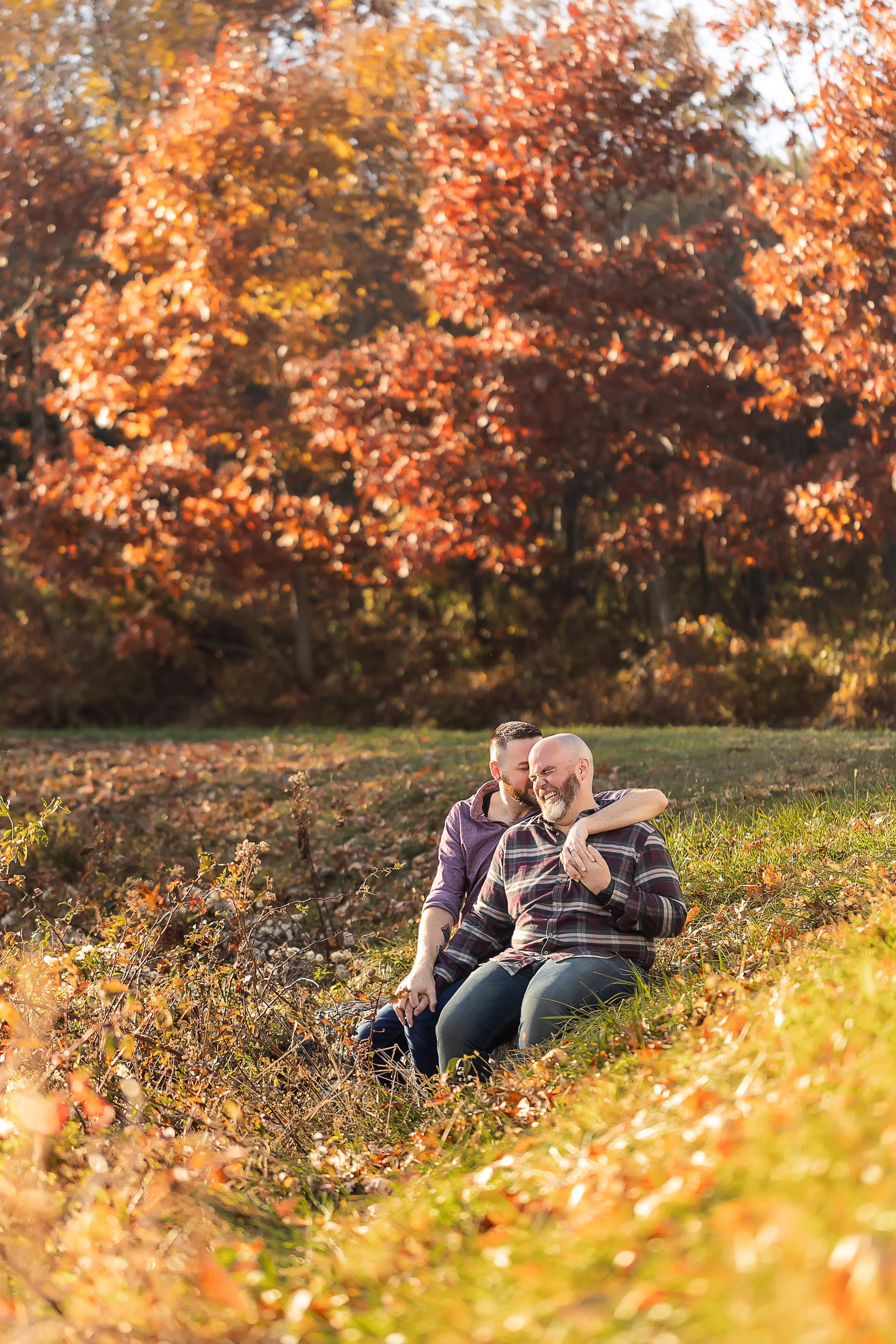 two men cuddling and laughing mountain engagement session nc lgbt