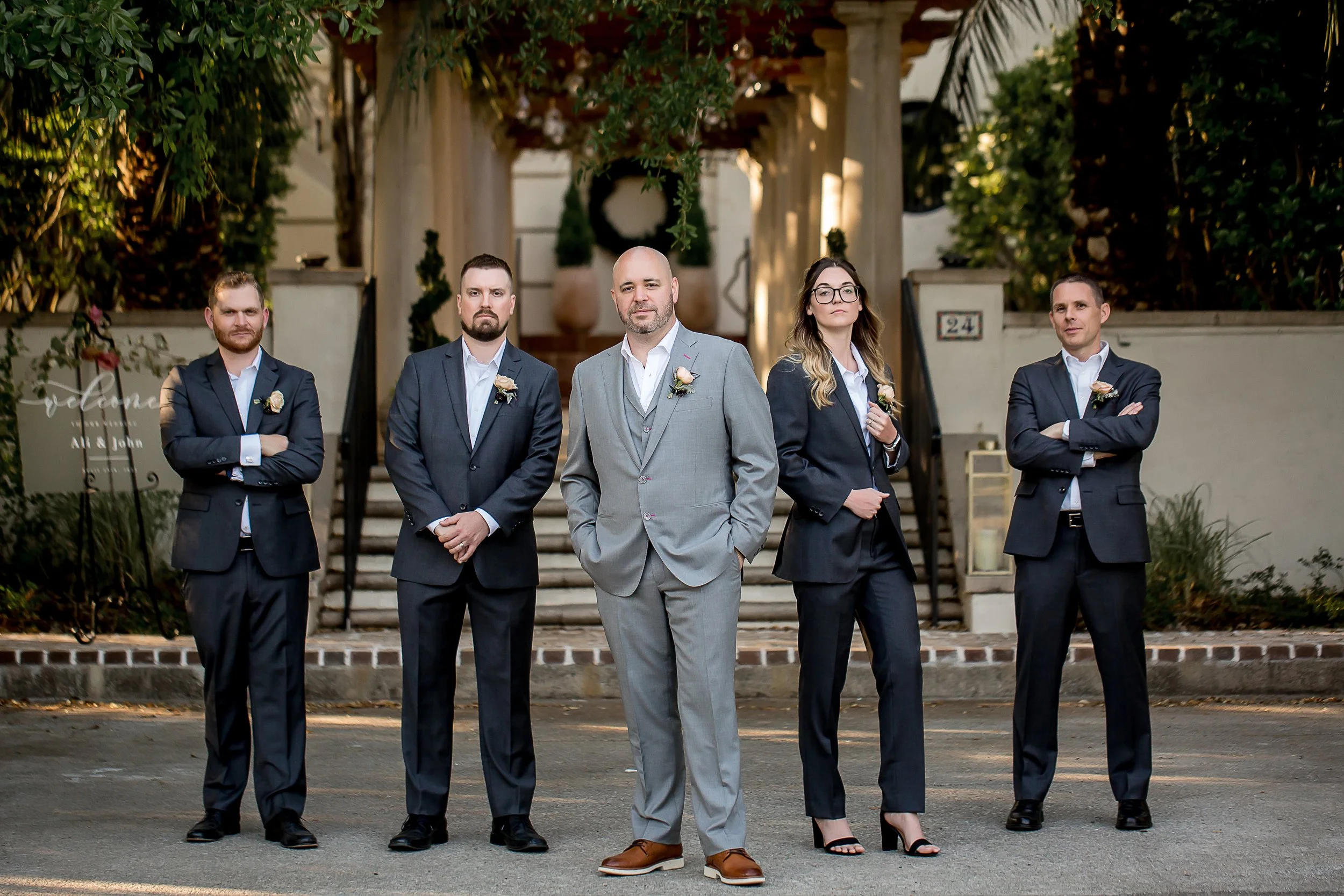 groom and wedding party pose in front of charleston mansion micro wedding destination