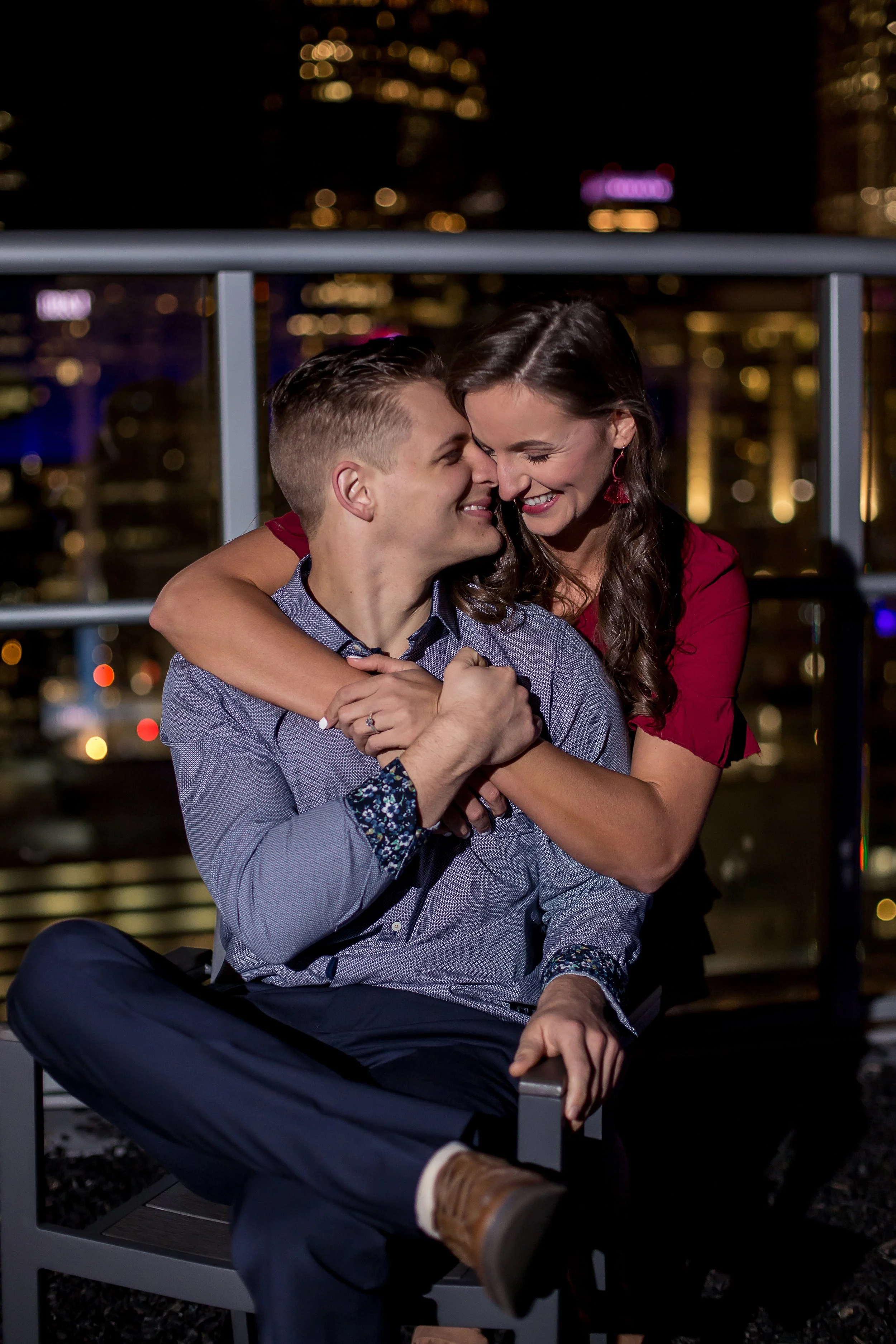 couple embraces on charlotte rooftop surprise proposal engagement