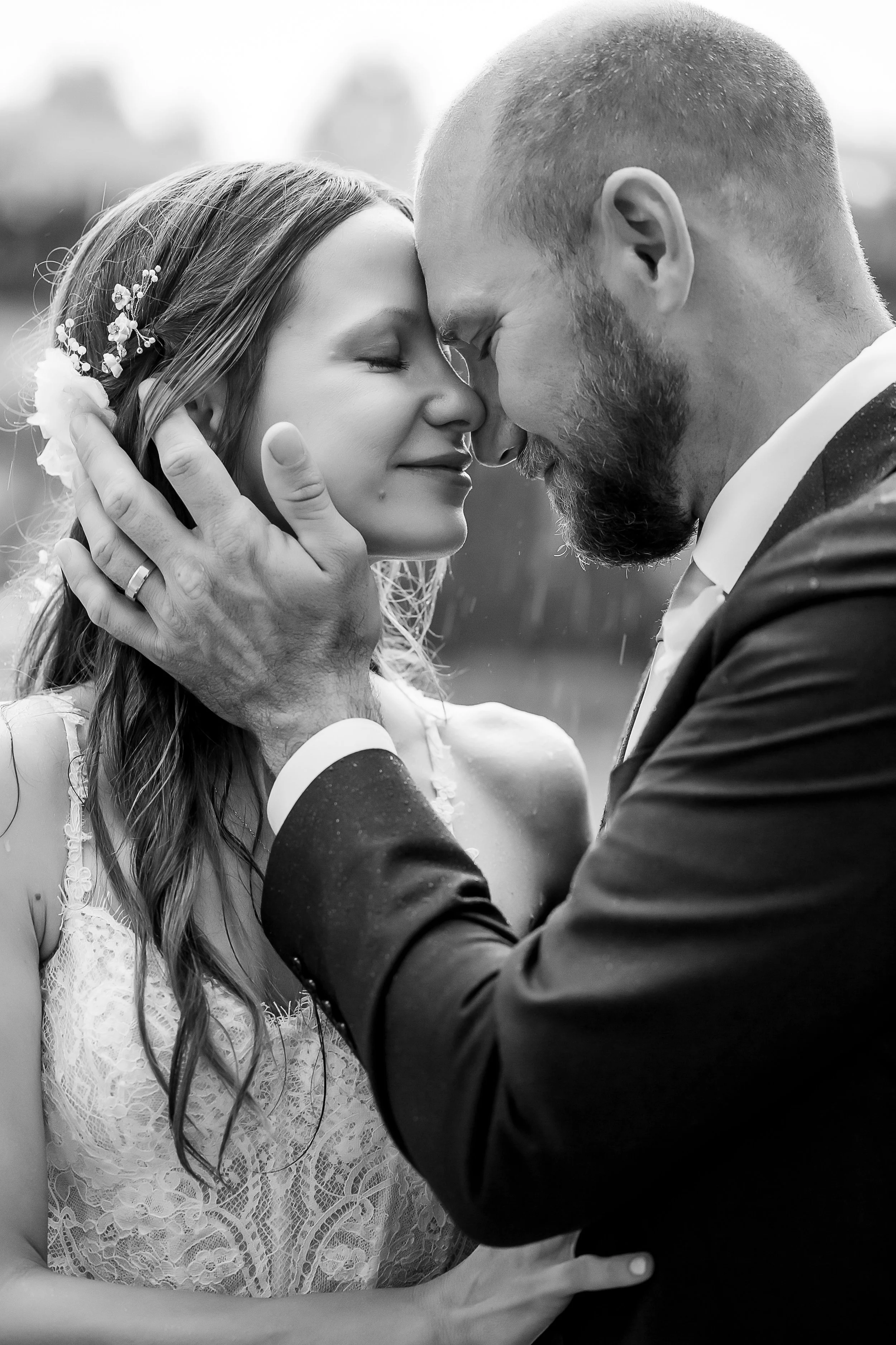 rainy day elopement black and white photo of couple embracing with their eyes closed in the rain