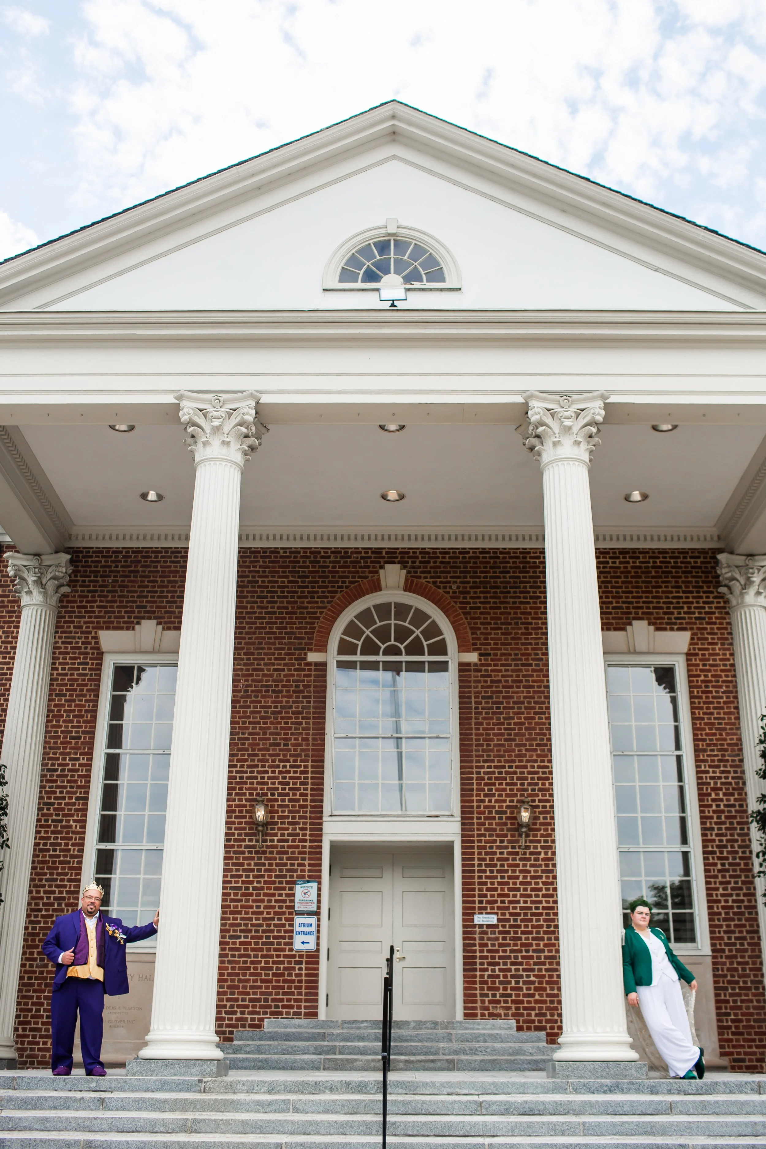 non traditional couple standing on old traditional building court steps