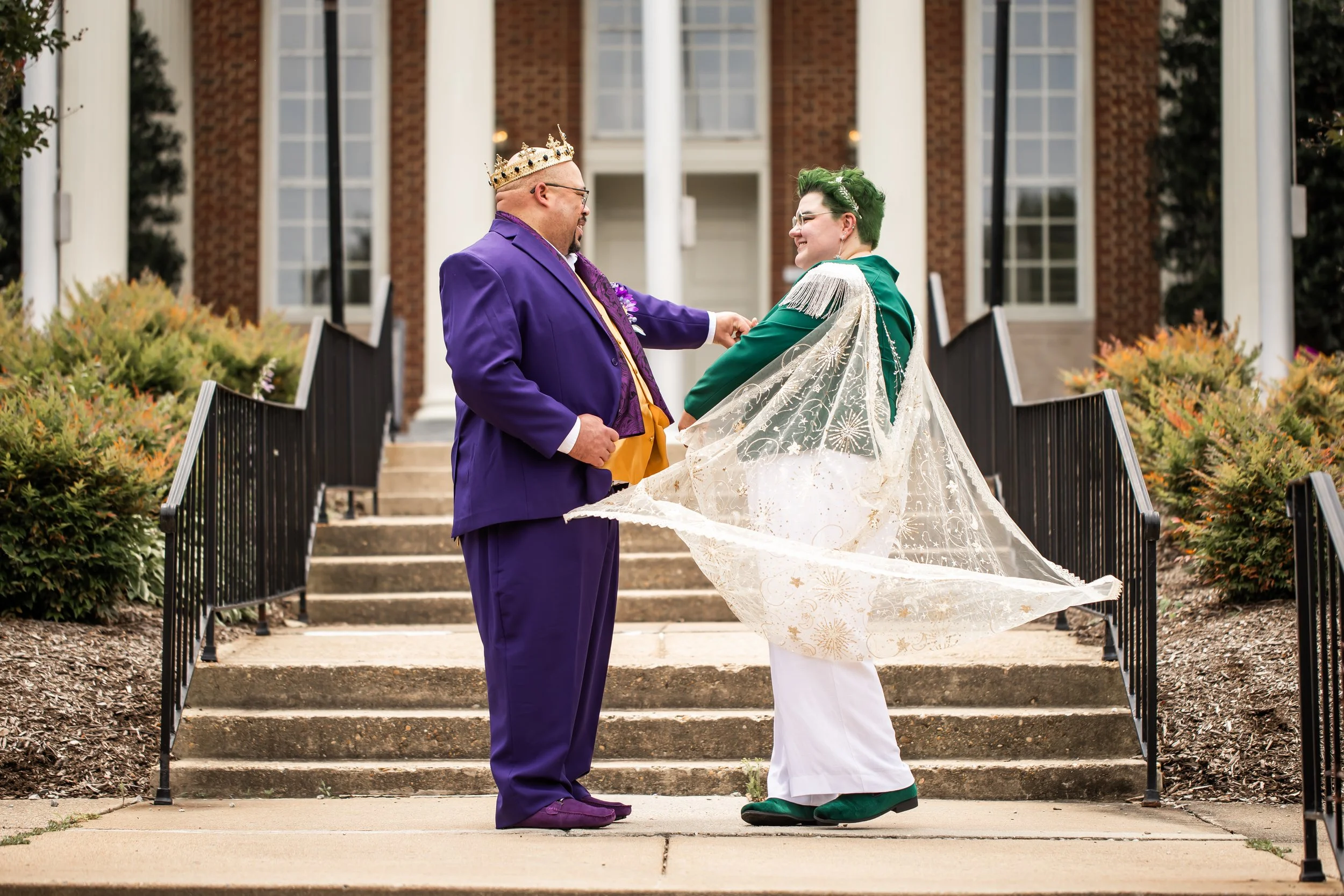 unique gender fluid couple twirls in front of courthouse after wedding