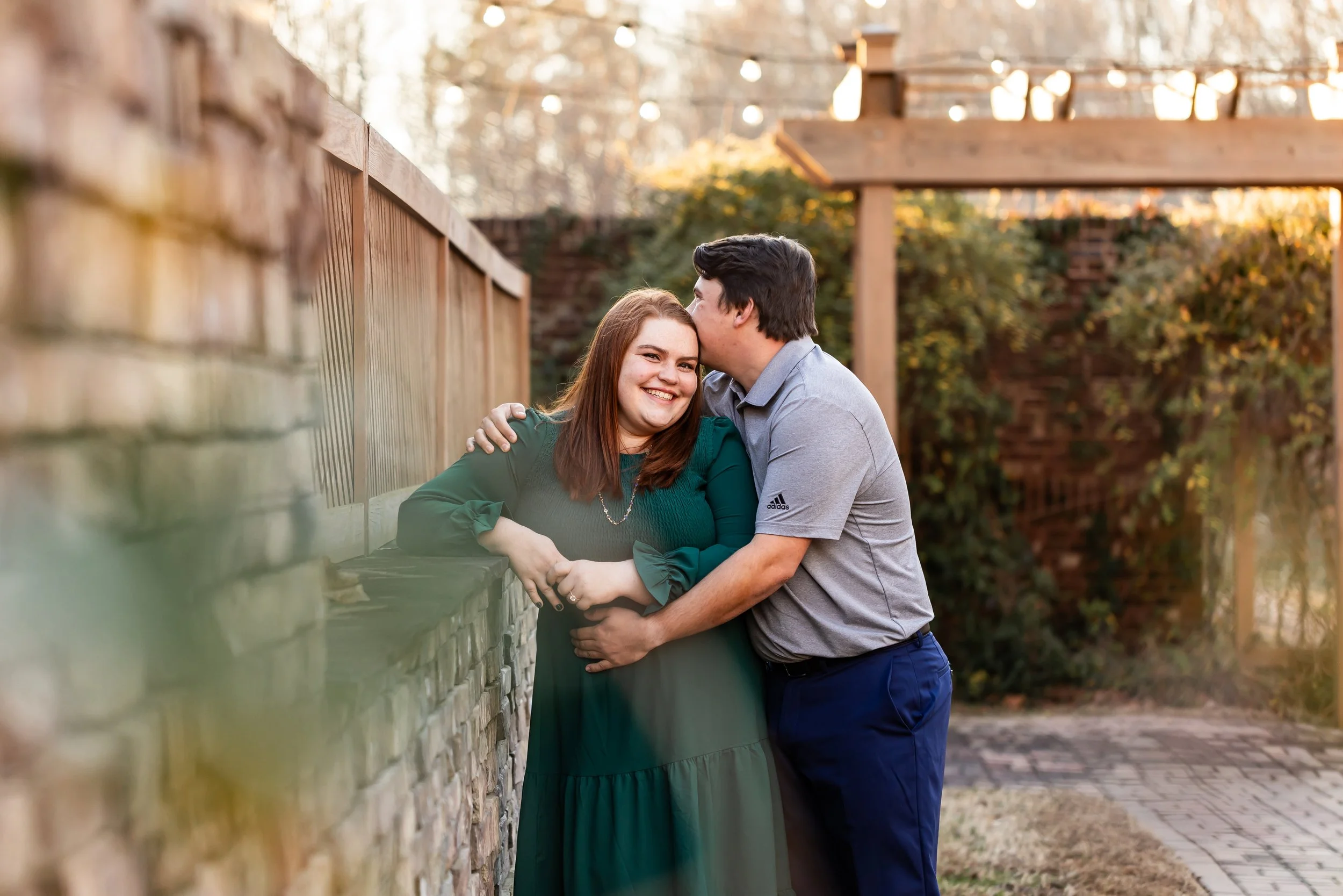 engagement session charlotte couple embracing green dress winter sun