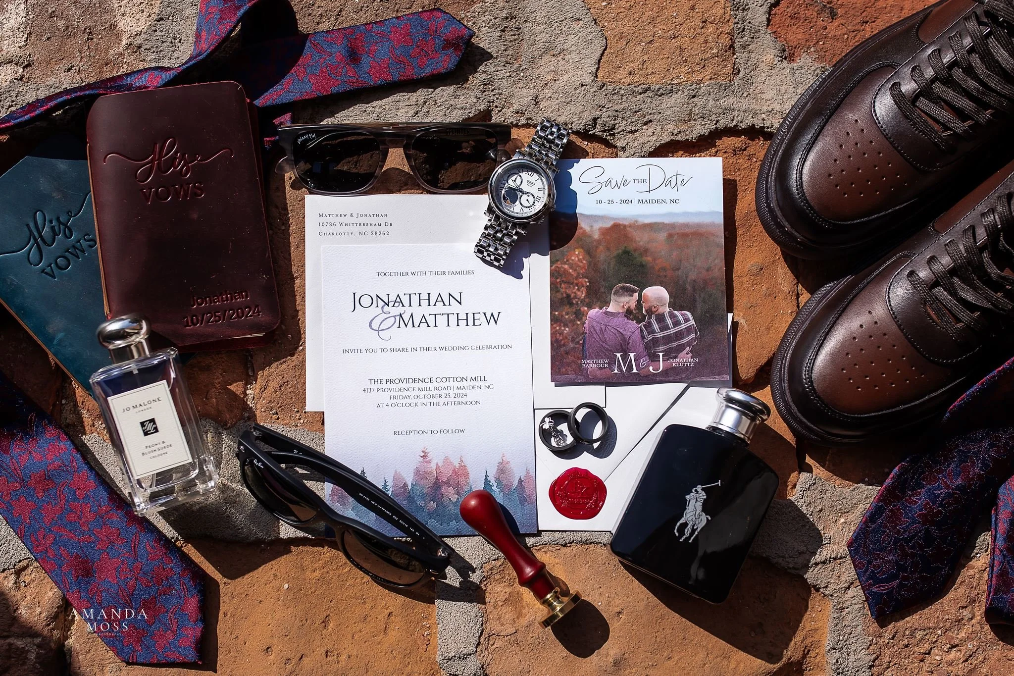 overhead flat lay photo of lgbt wedding details two grooms shoes vow books rings invitations
