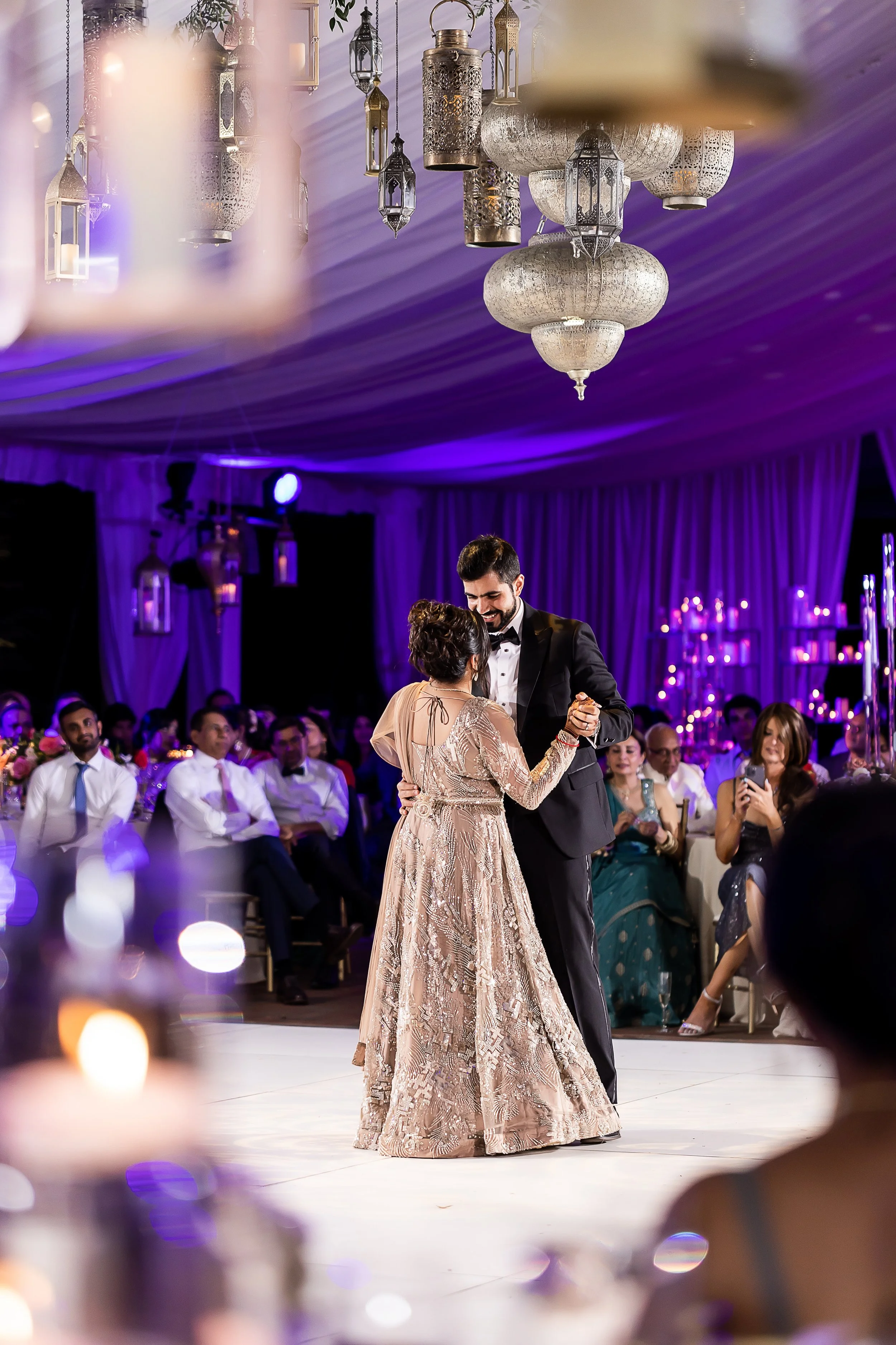 hindu indian wedding reception elaborate arabic style decor purple lighting couple dancing