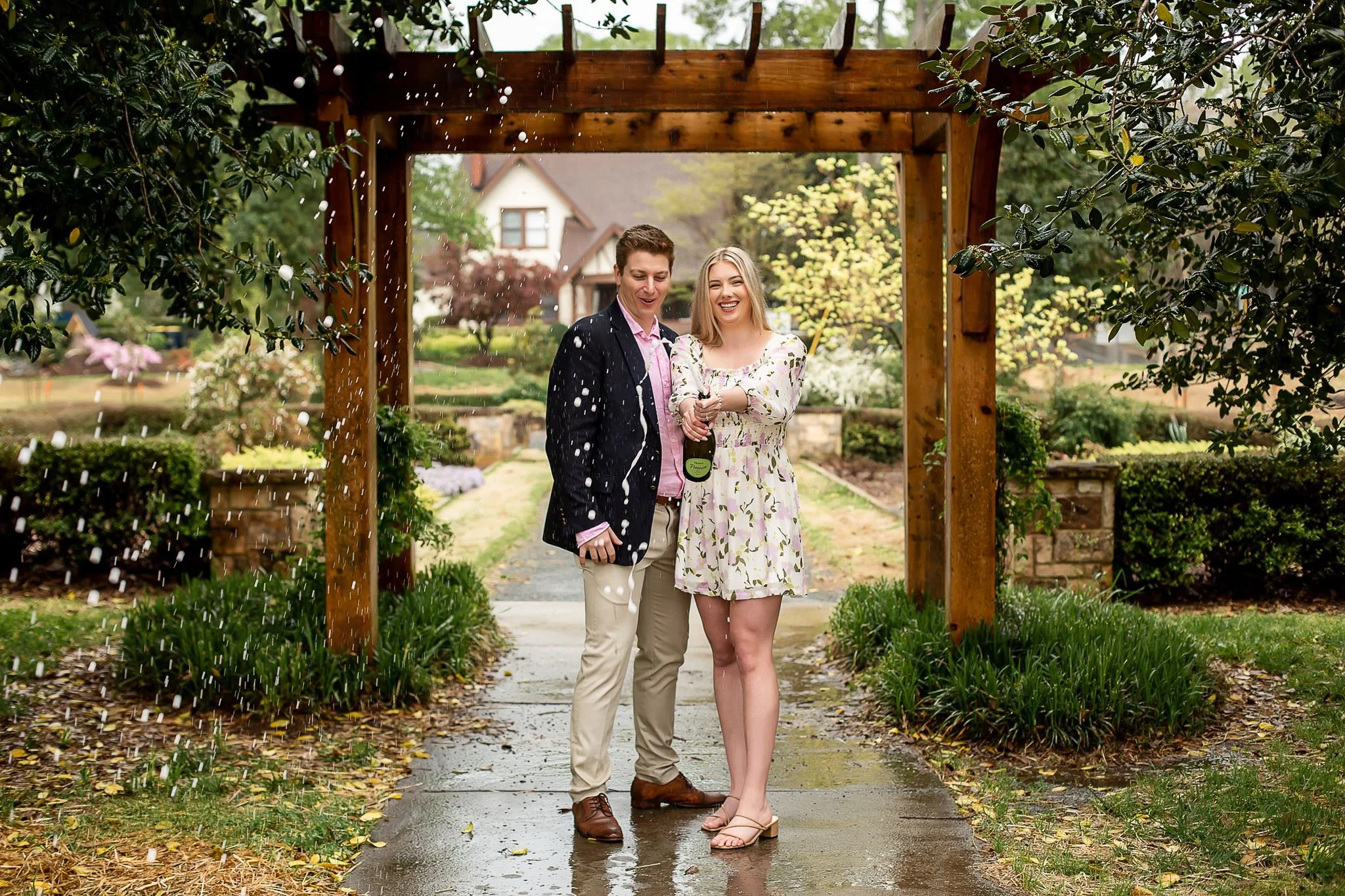 couple celebrates with champage after surprise proopsal