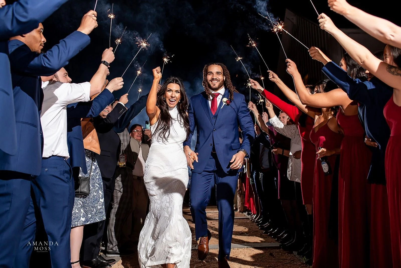 bride and groom walk through sparkler exit after their wedding at barn of chapel hill