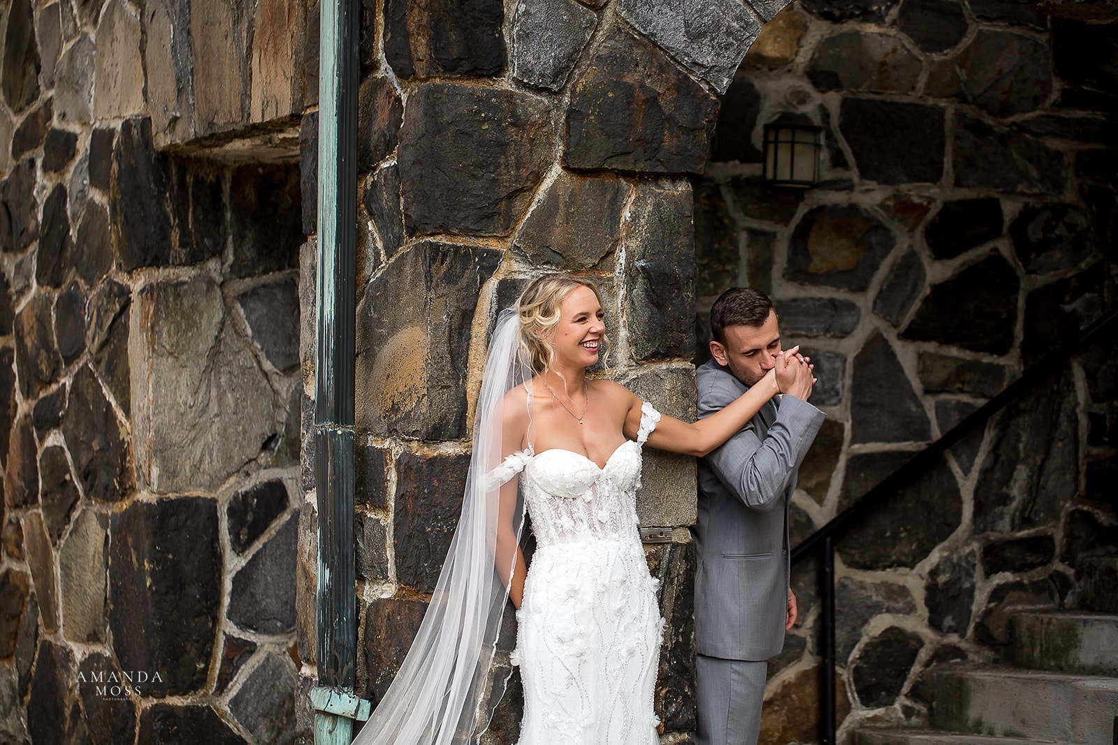 groom kisses brides hand in a private first touch moment before their wedding ceremony