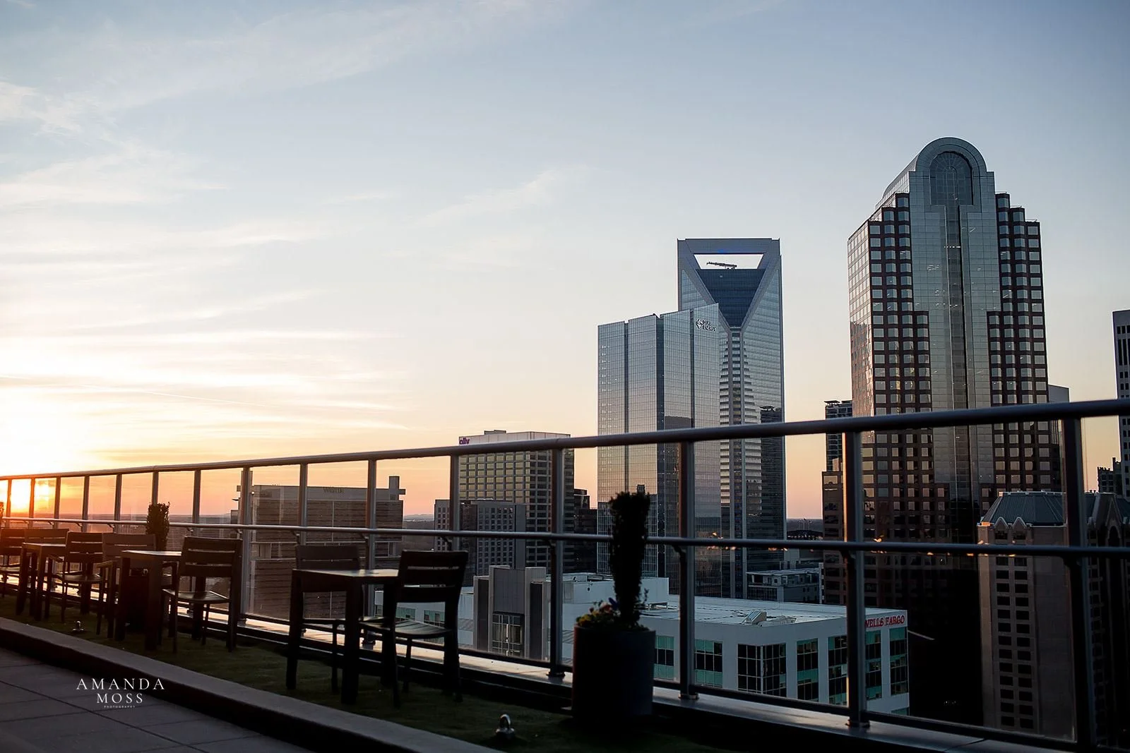 sunset over the charlotte skyline from the rooftop of fahrenheit