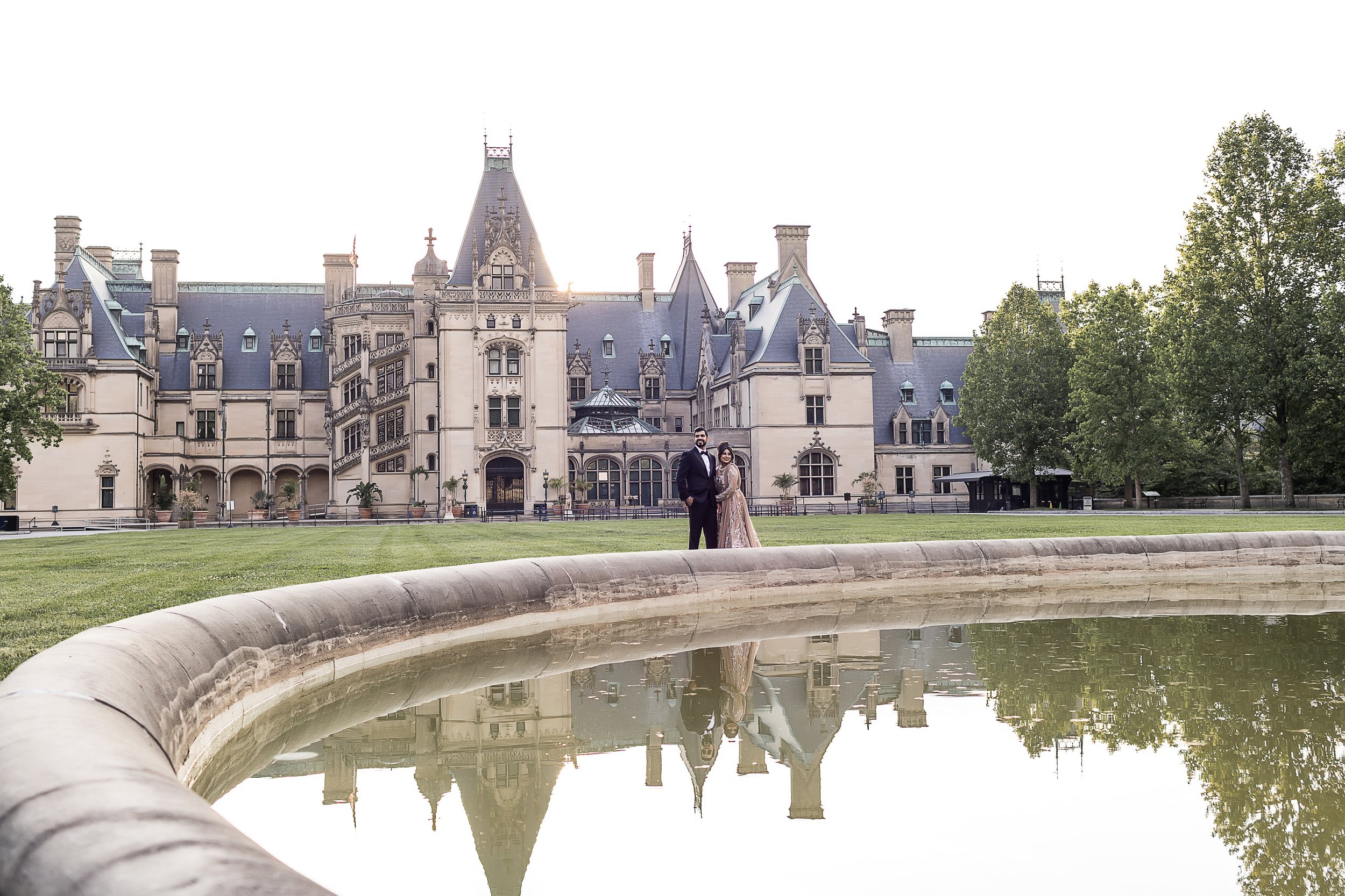 Hindu bride and groom pose in front of the biltmore estate in asheville north carolina
