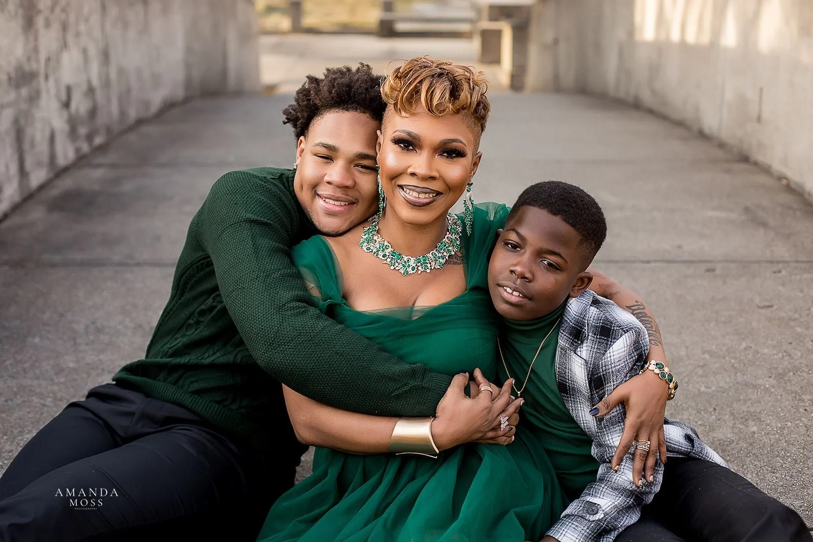 mother and sons embrace during outdoor family photos shoot at marshall park in charlotte nc