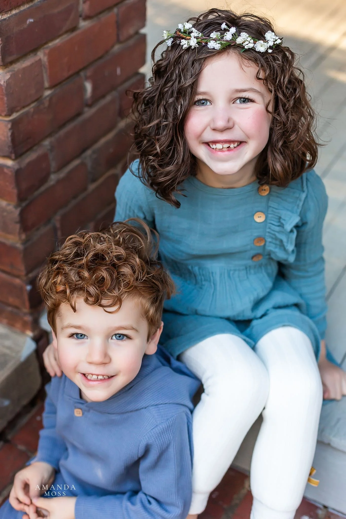 brother and sister smile at the camera during outdoor family photo session in rock hill sc glencairn gardens