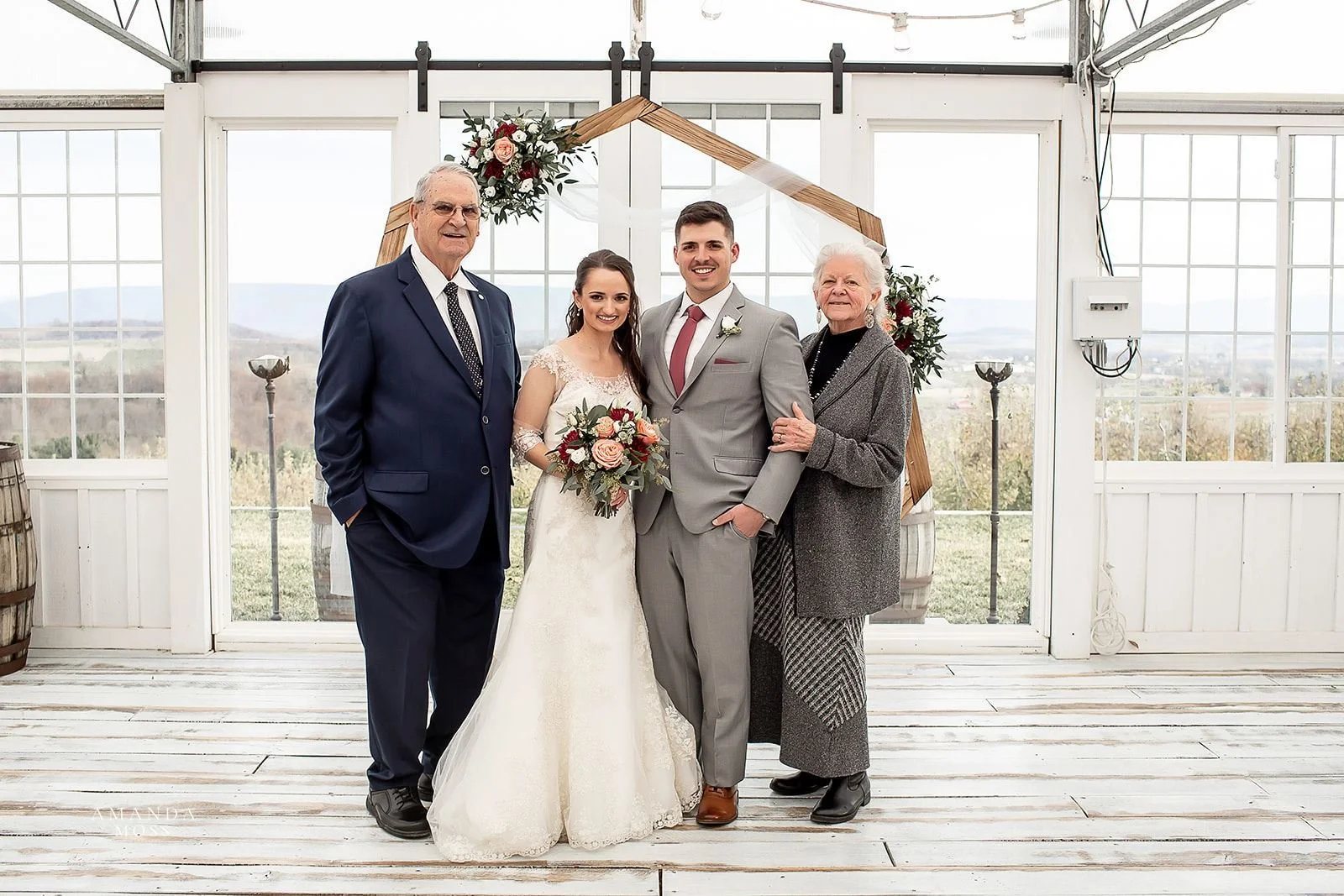 bride and groom pose with grandparents for family photo after wedding at showalters orchard in virginia
